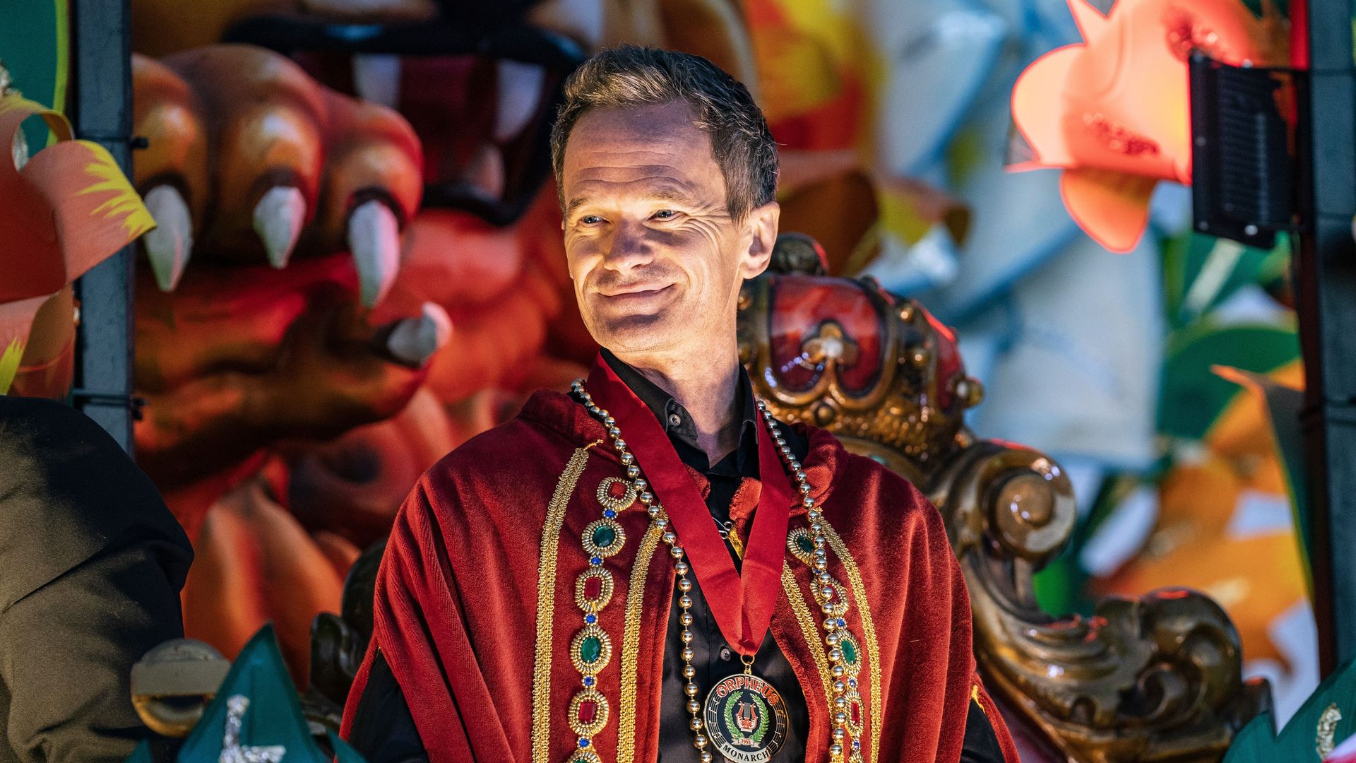 Photo shows Neil Patrick Harris smiling on a float