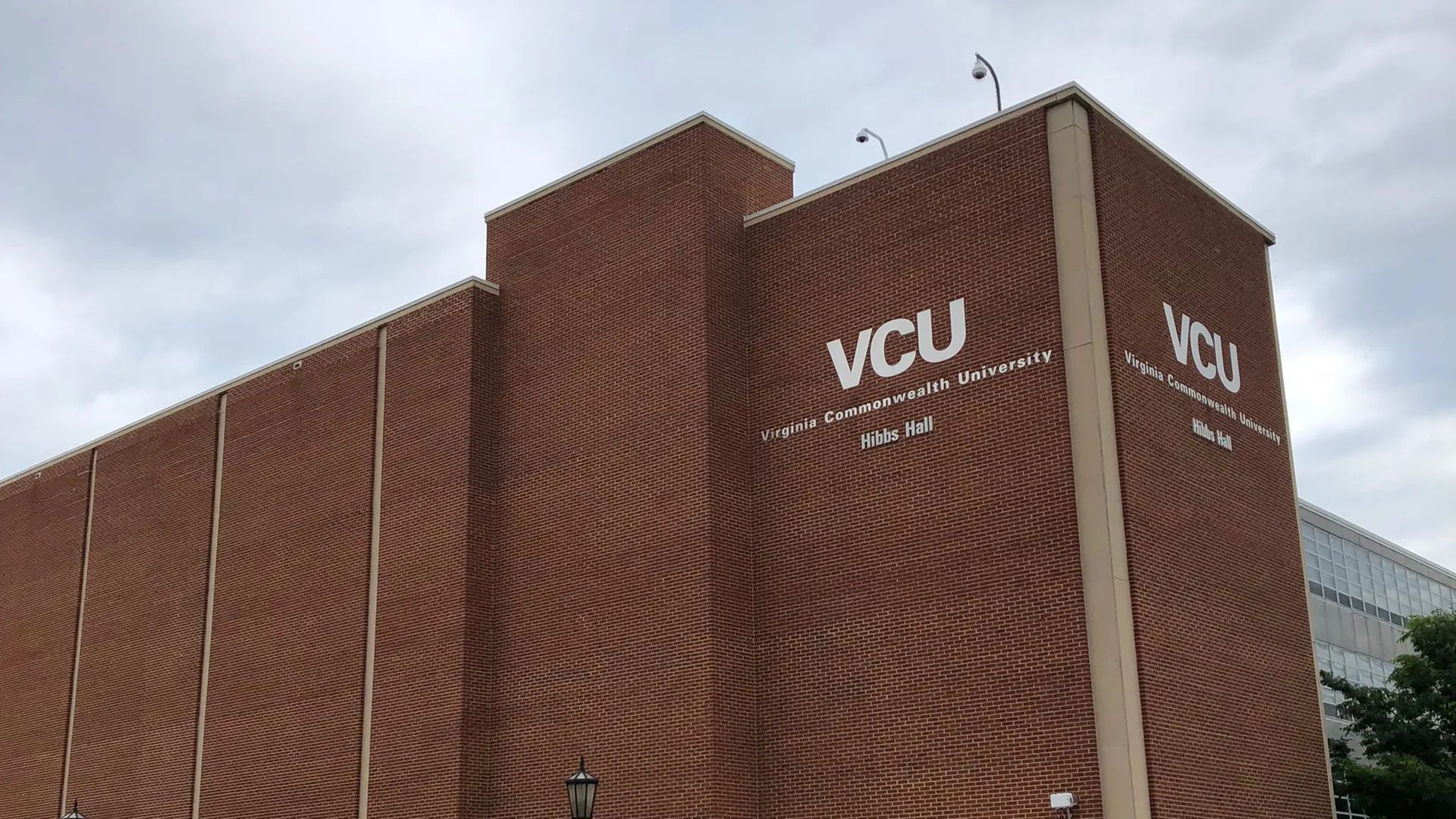 A brown building with the words "VCU Virginia Commonwealth University Hibbs Hall" written in white