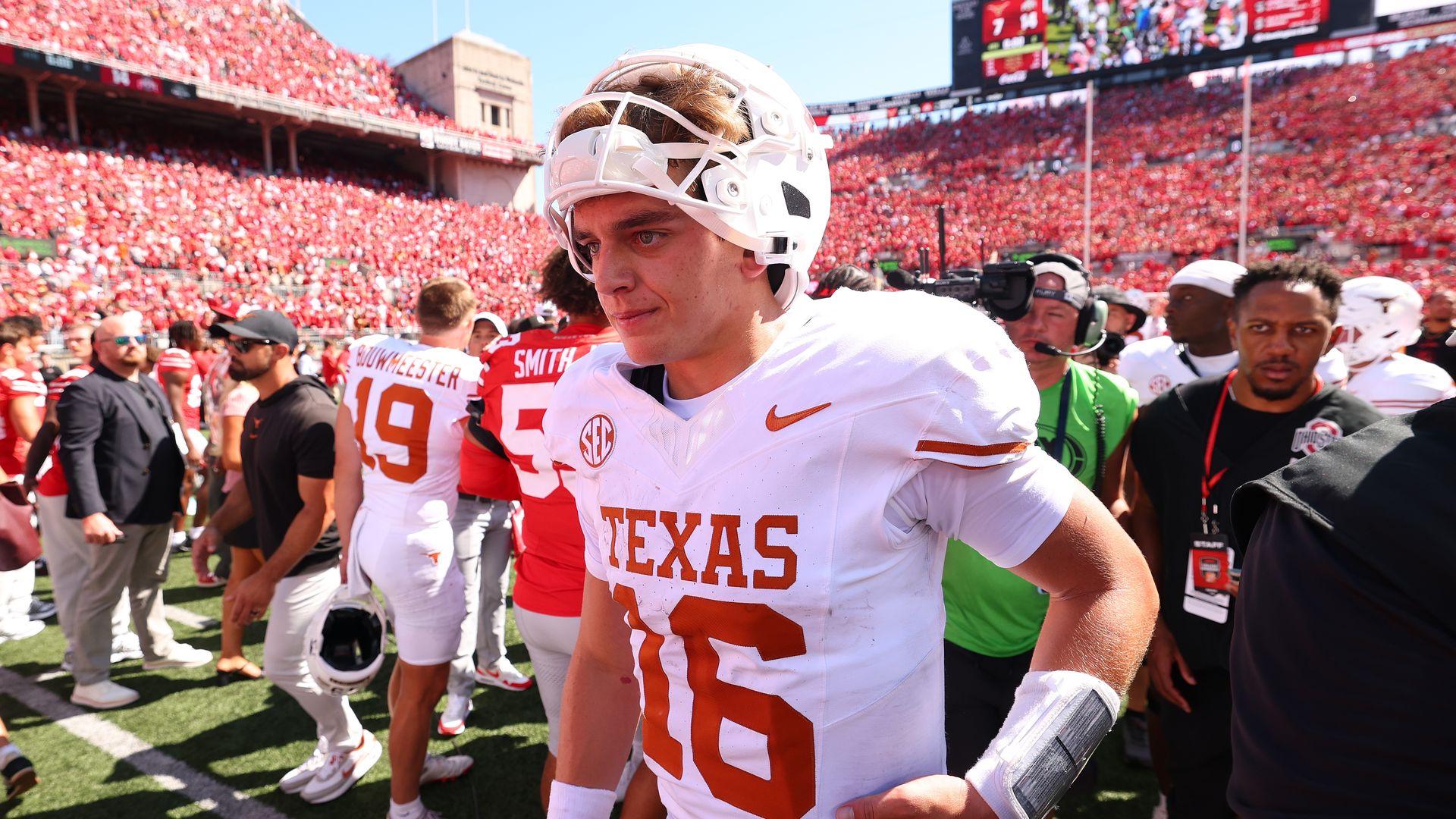 Arch Manning, helmet perched on head, leaving the field after a game this season.
