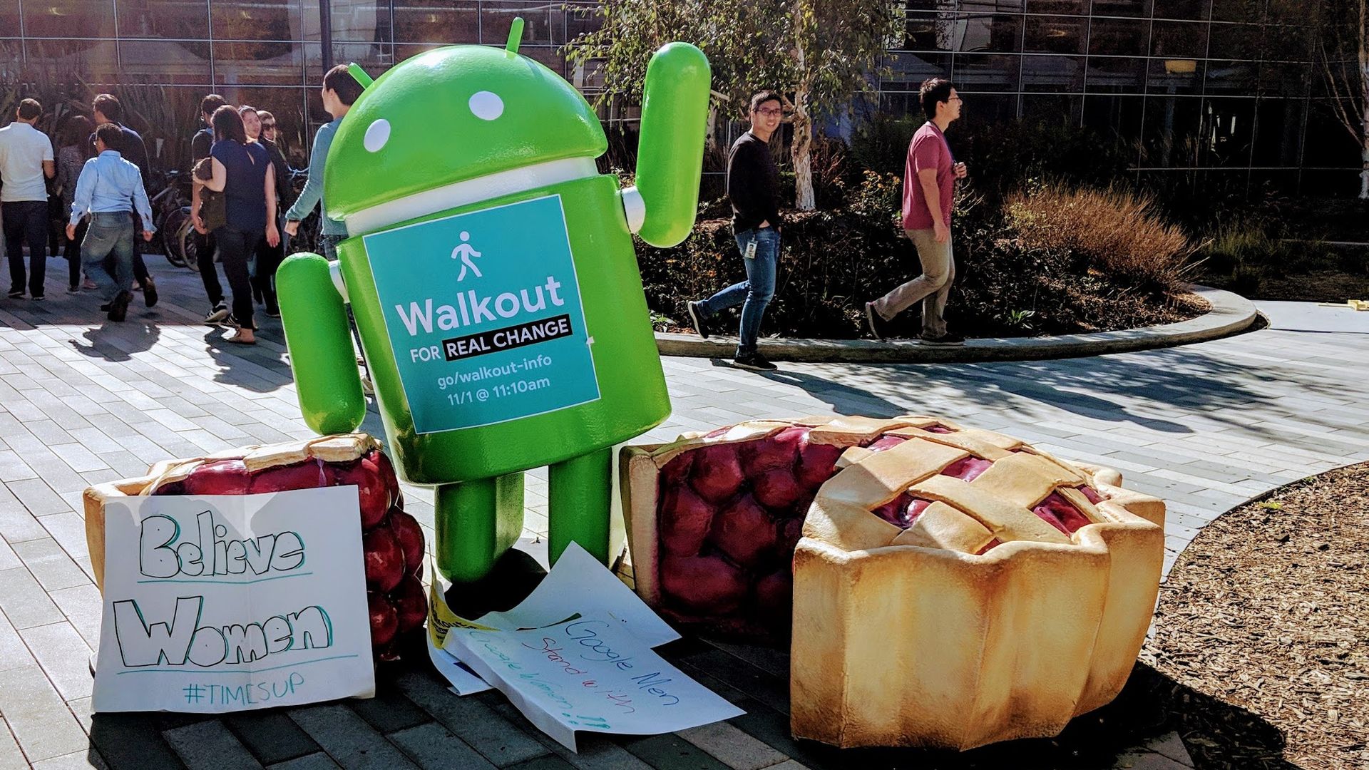 An Android Pie statue on Google's campus with signs from the worker protest.