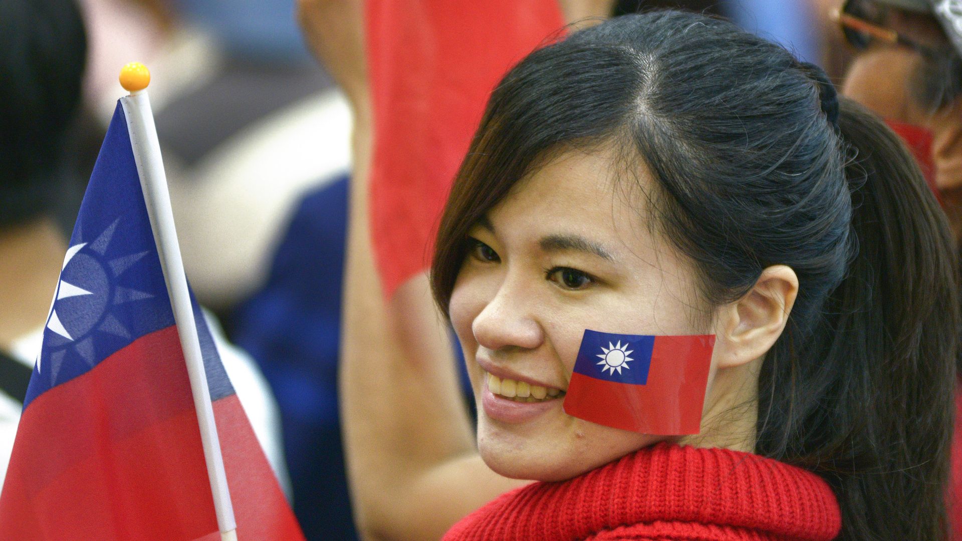 Photo of a girl in Taiwan holding a flag