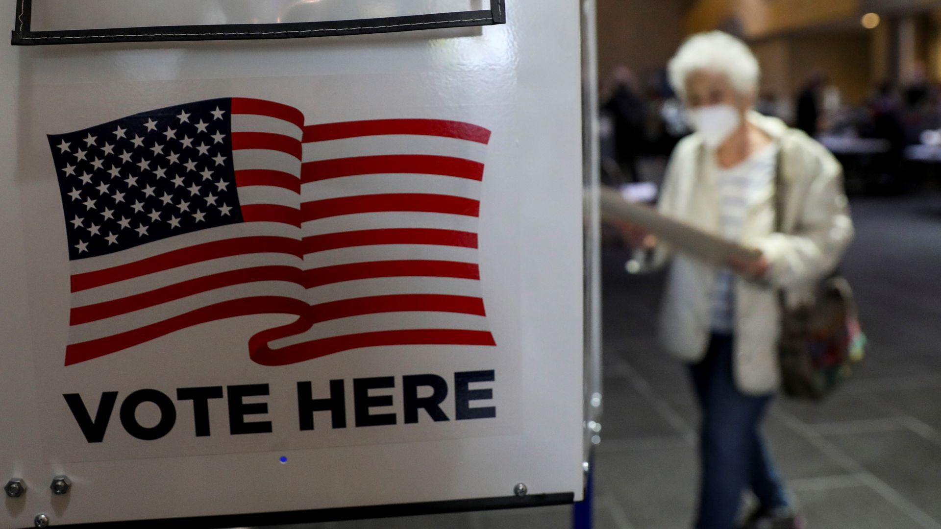 Picture of a sign that says "vote here" in a polling station in New York.
