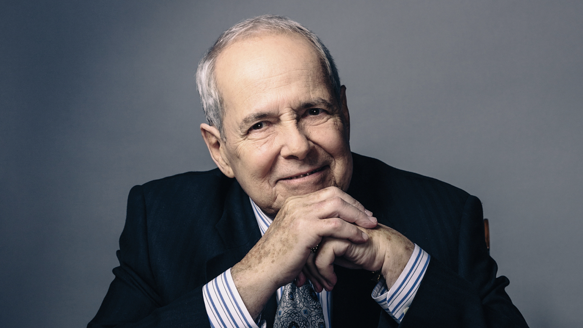 A photo of former Mayor Sam Massell sitting at a table with his hands against his chin