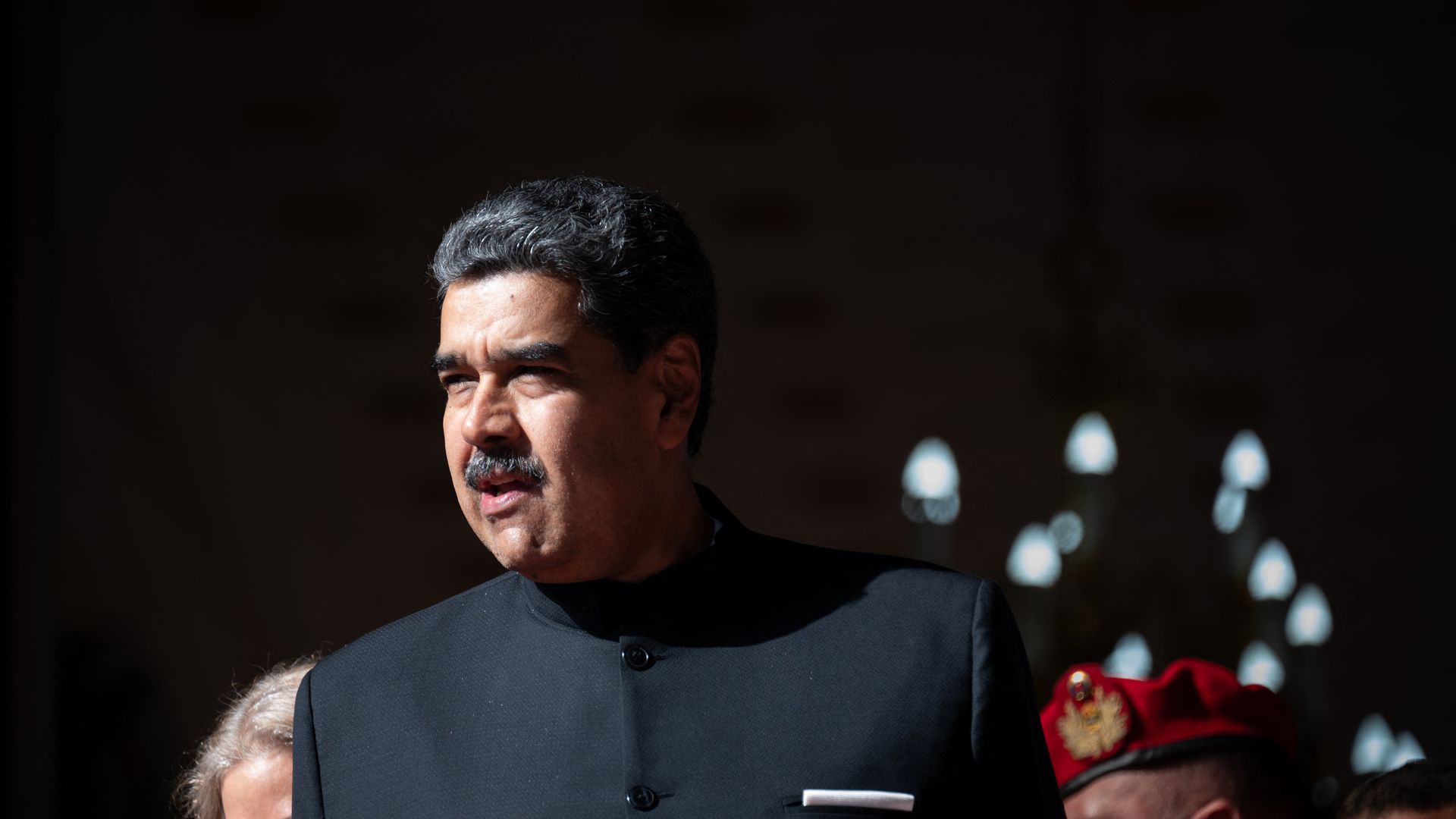 Venezuela President Nicolas Maduro, dressed in black, looks off to the side. 