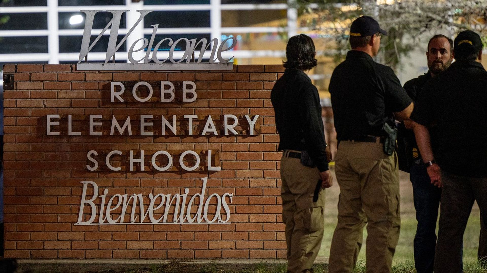 Law enforcement officers speak together outside of Robb Elementary School following the mass shooting on May 24 in Uvalde, Texas.