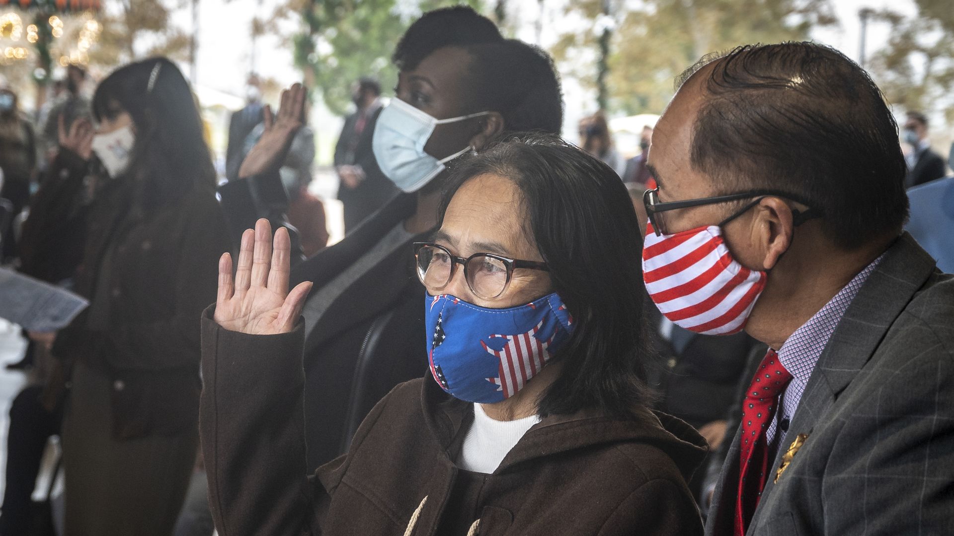 Ngoc Nguyen of Vietnam takes the Oath of Allegiance as her cousin, Buu-Van A.J. Rashi, translates for her during a U.S. naturalization ceremony