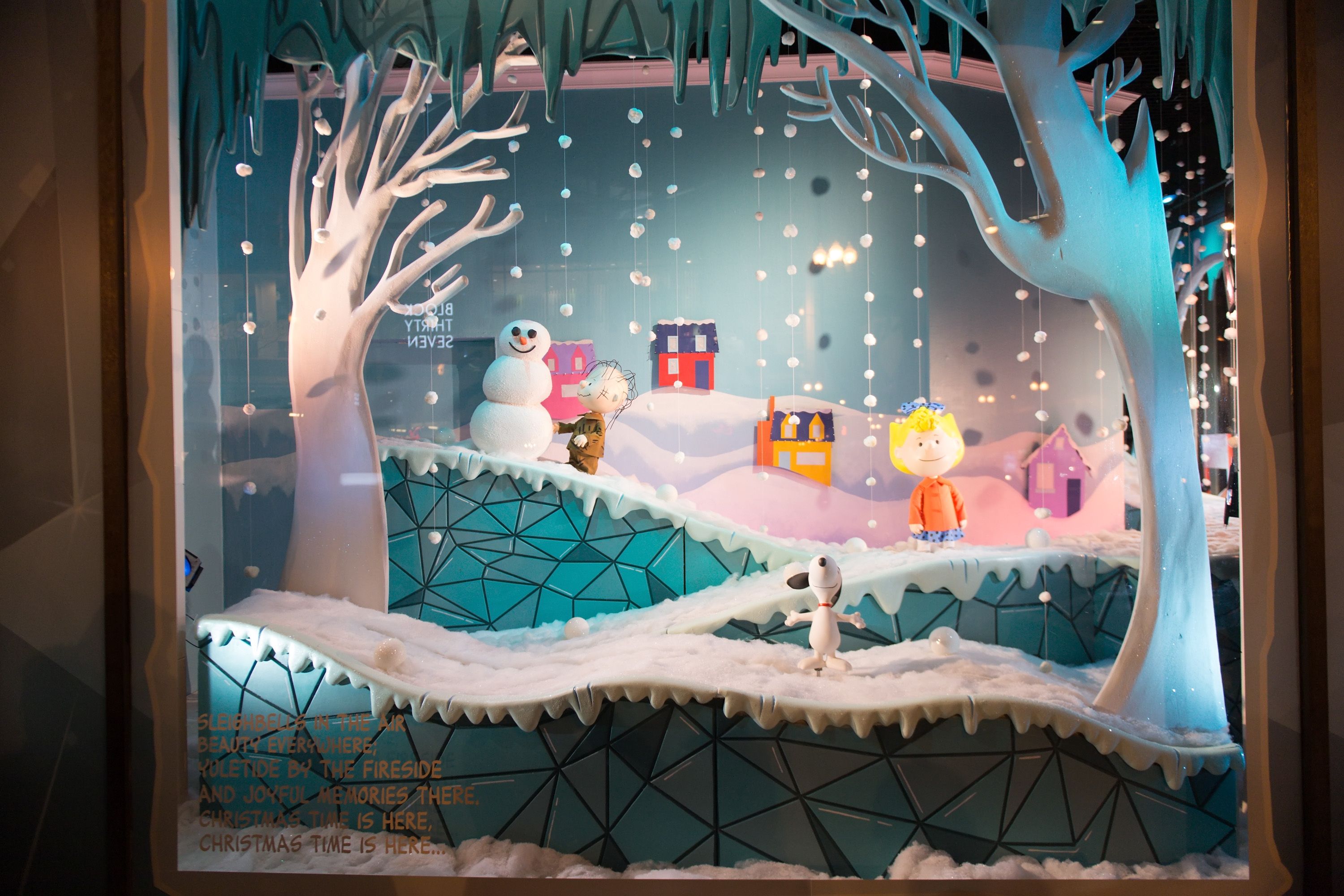 Photo of a window display in a department store with snowmen and figurines skating 