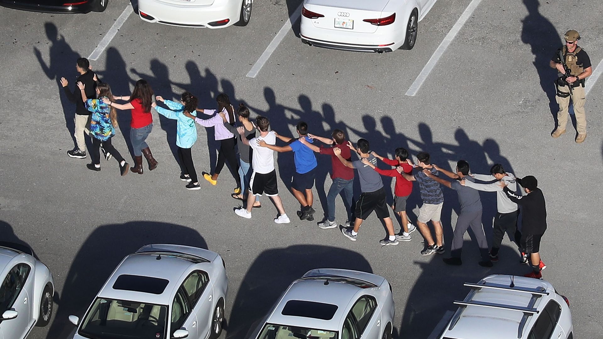 People being brought out of the Marjory Stoneman Douglas High School after a shooting at the school on February 14, 2018 in Parkland, Florida.