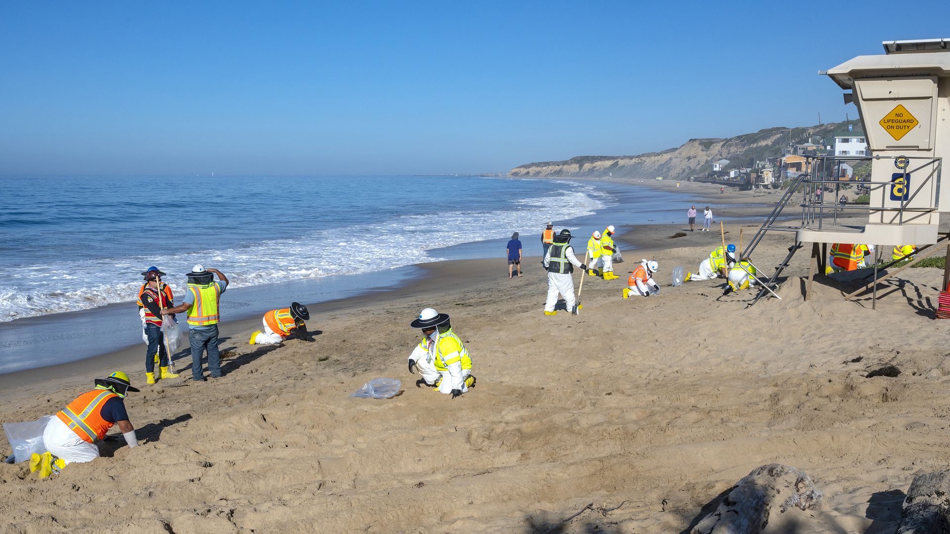 Shoreline cleanup crews pick up tar balls 