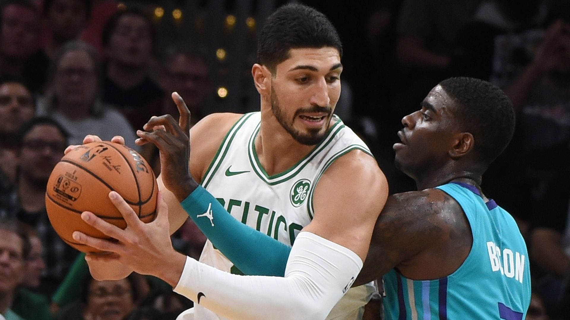 Celtics center Enes Kanter driving against Charlotte Hornets guard Dwayne Bacon in Boston in October 2019.