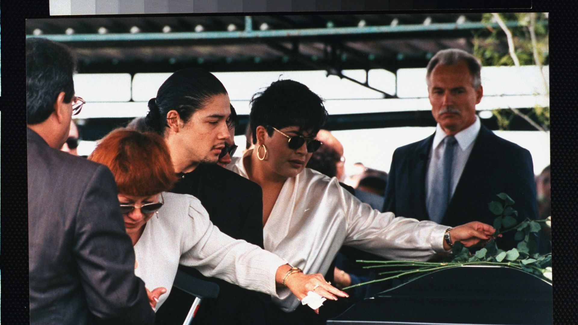 the family of Selena Quintanilla touches her black casket