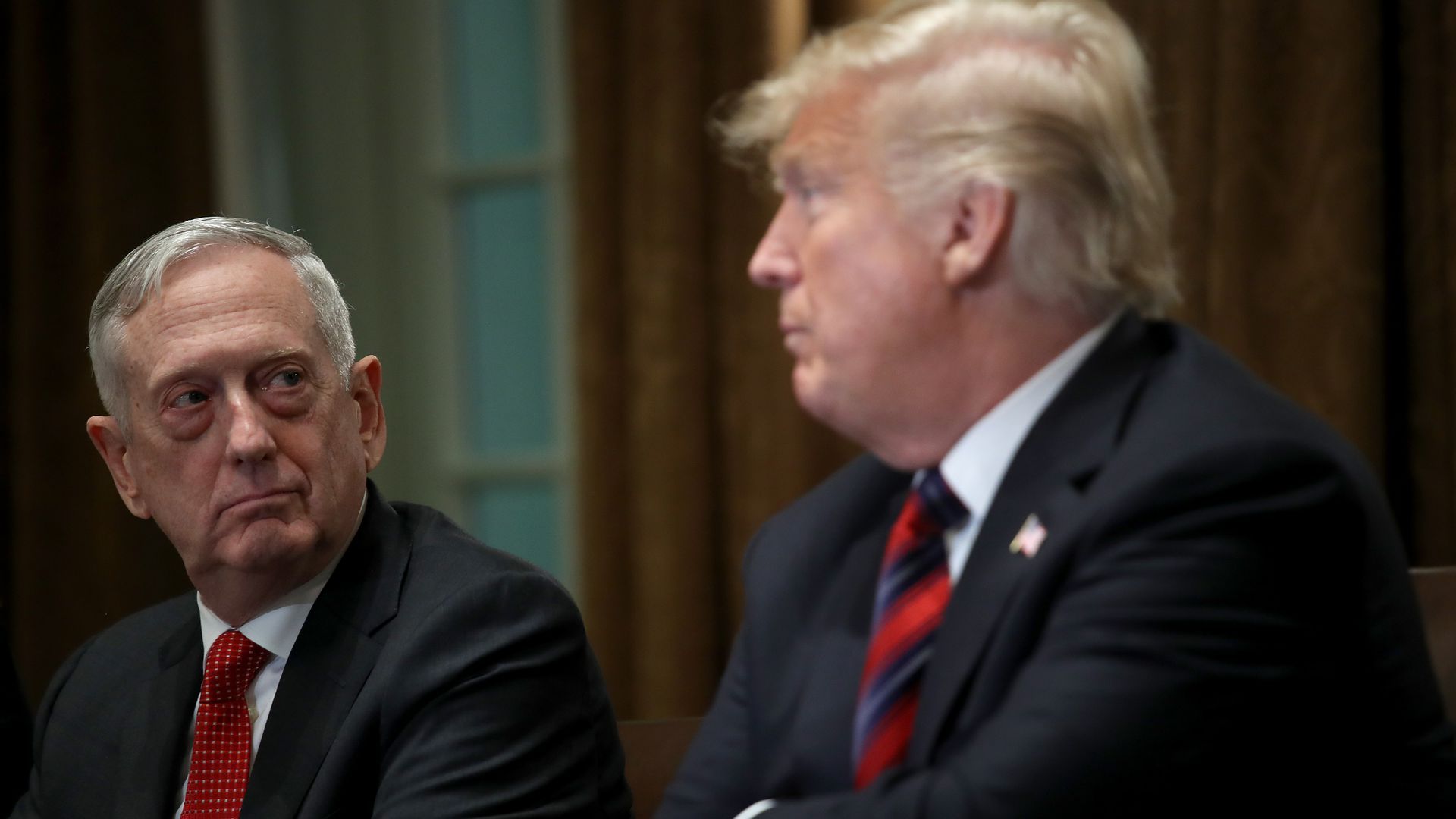 Mattis on the left looks at President Trump