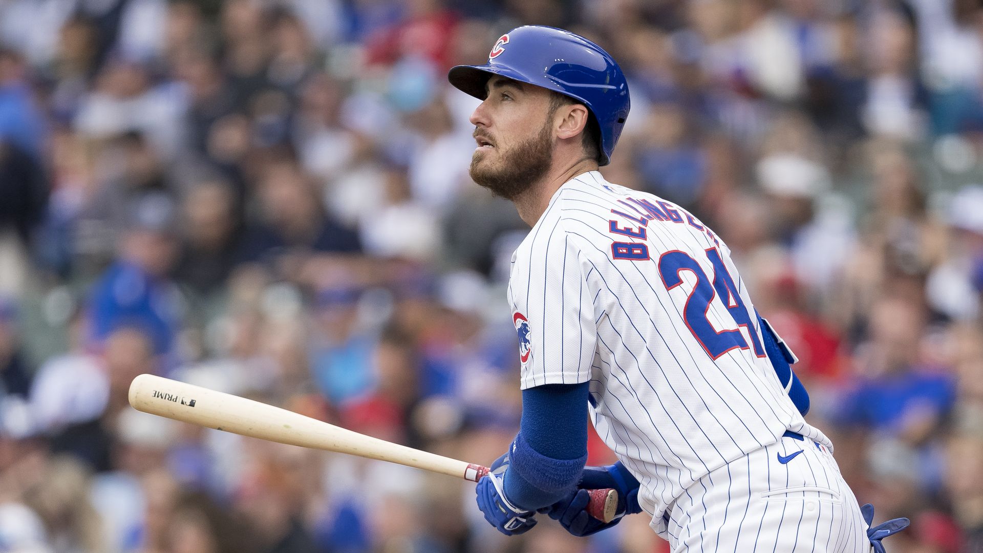 Photo of a baseball player with a bat in his hands looking to the sky after swinging it 