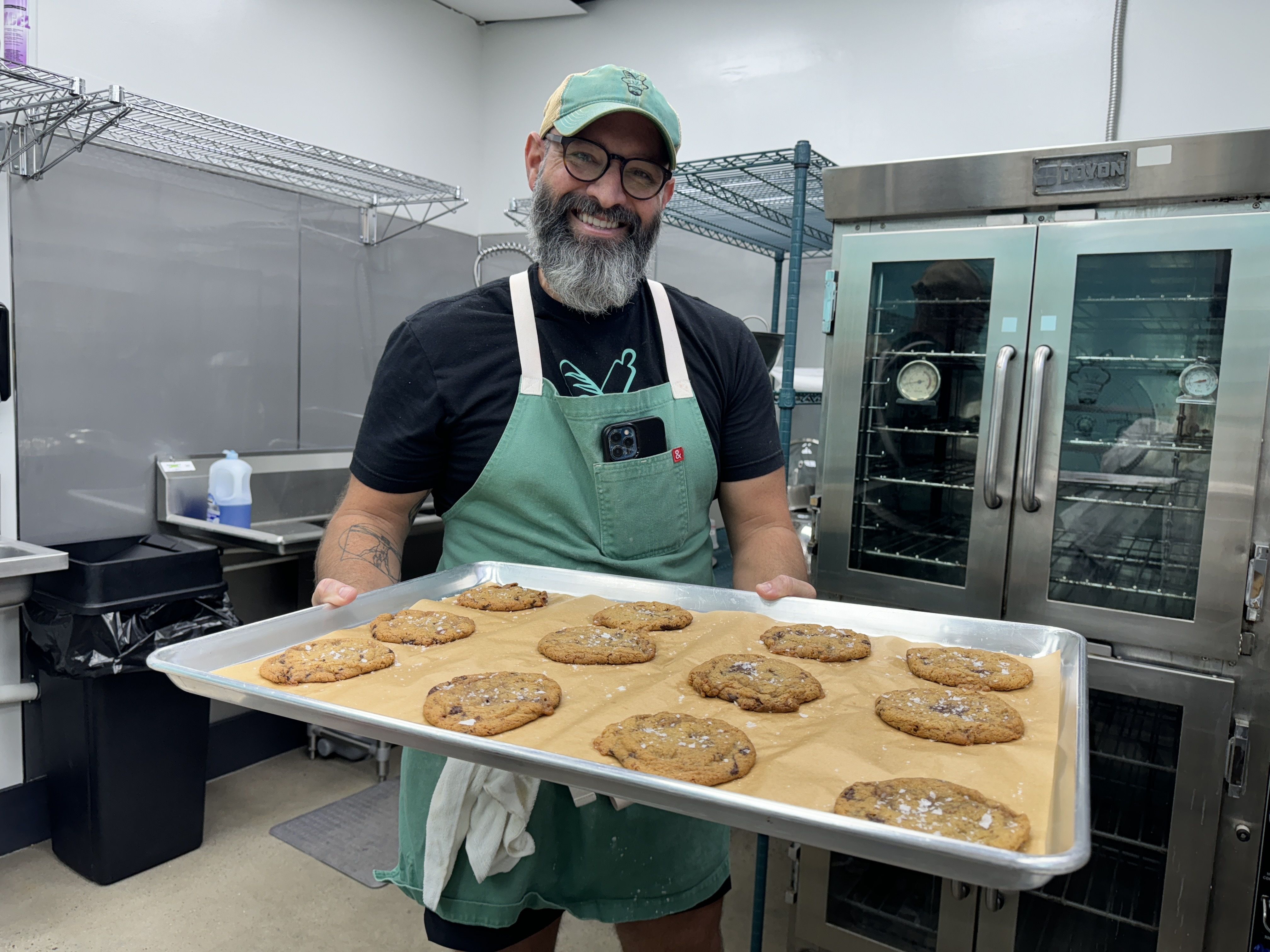man holding cookie tray