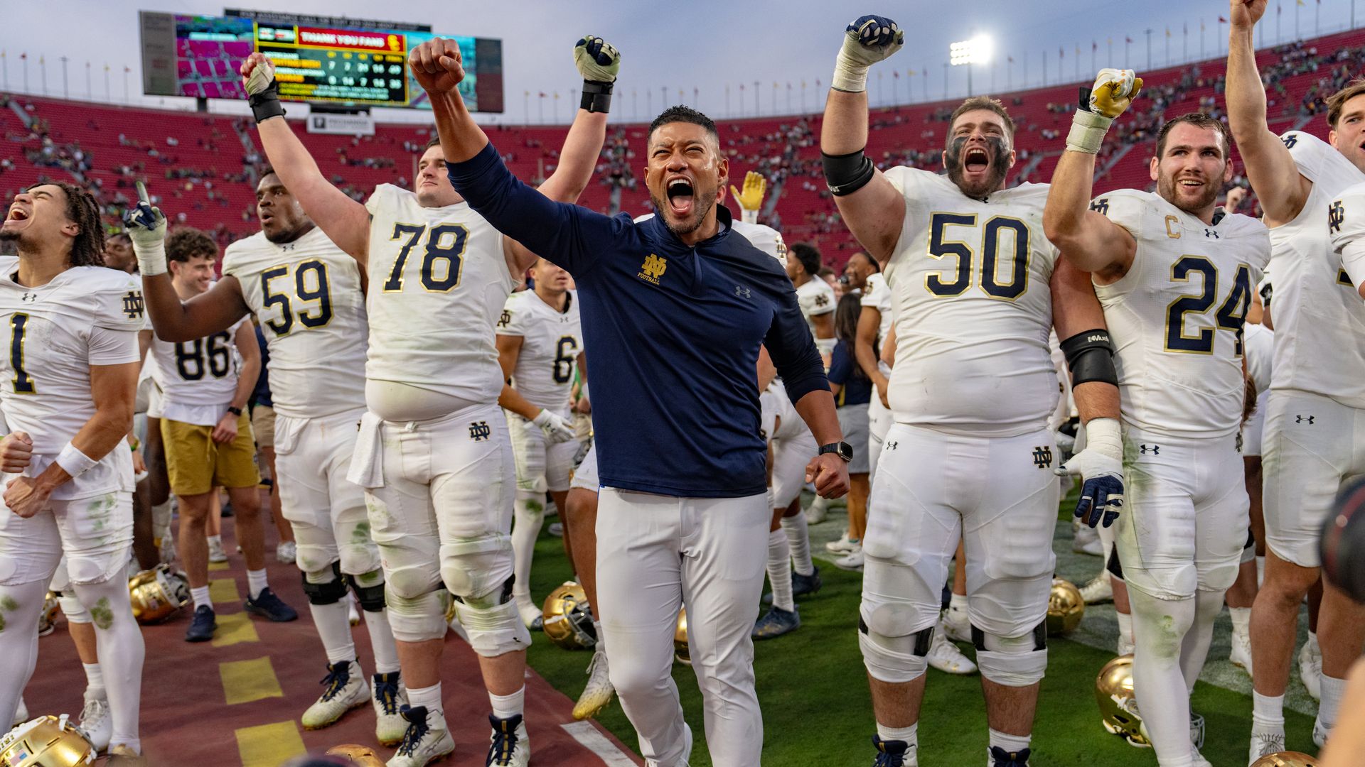 Marcus Freeman, Head Coach of the Notre Dame Fighting Irish football team celebrates victory with team during a game between Notre Dame Fighting Irish and University of Southern California at Los Angeles Memorial Coliseum on November 30, 2024 in Los Angeles, California.