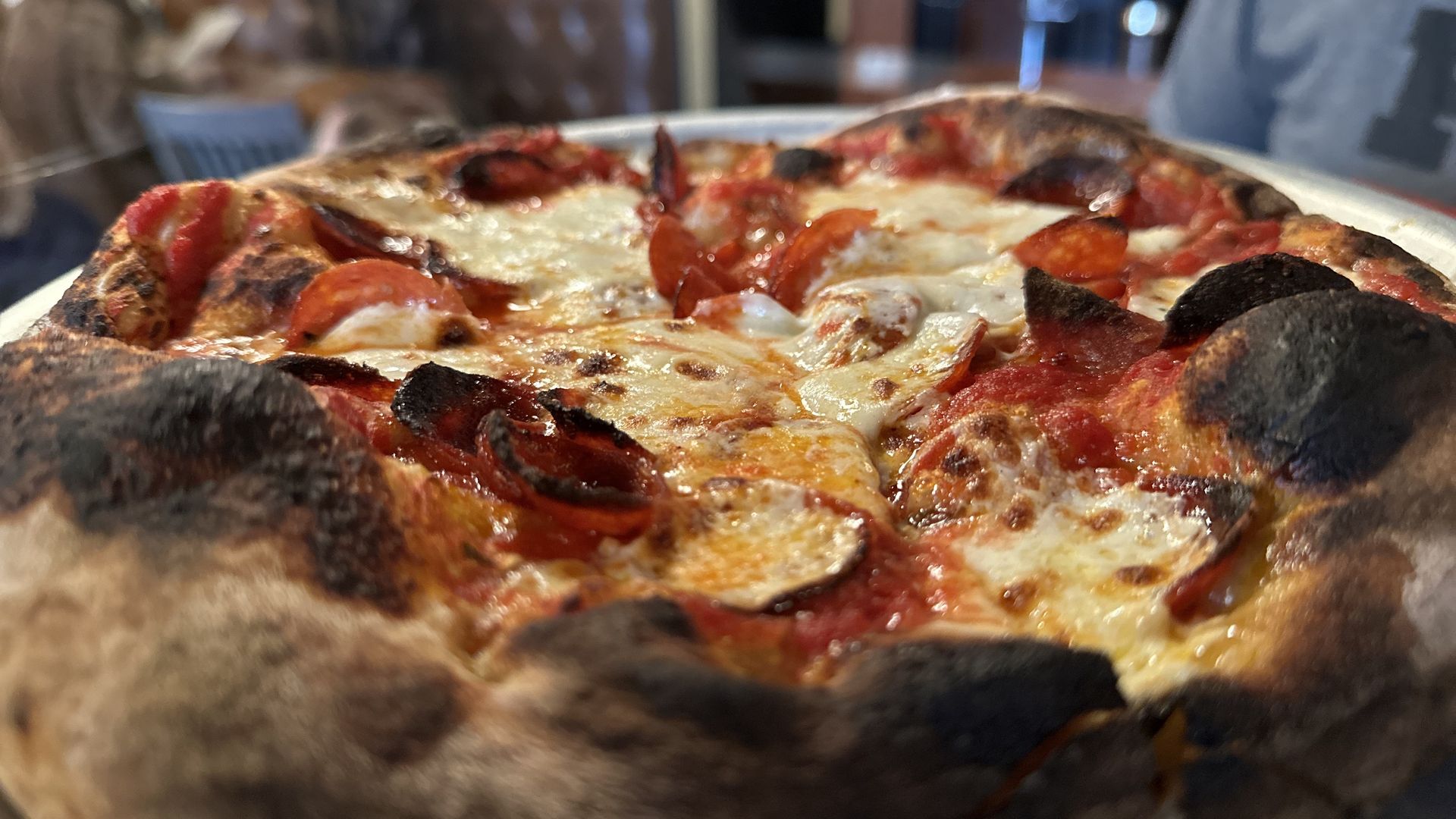 A close up shot of Picco's pepperoni pizza, including the charred crust.