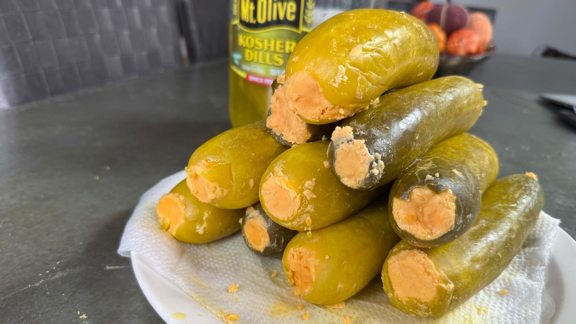A pile of pickles stuffed with cheese.
