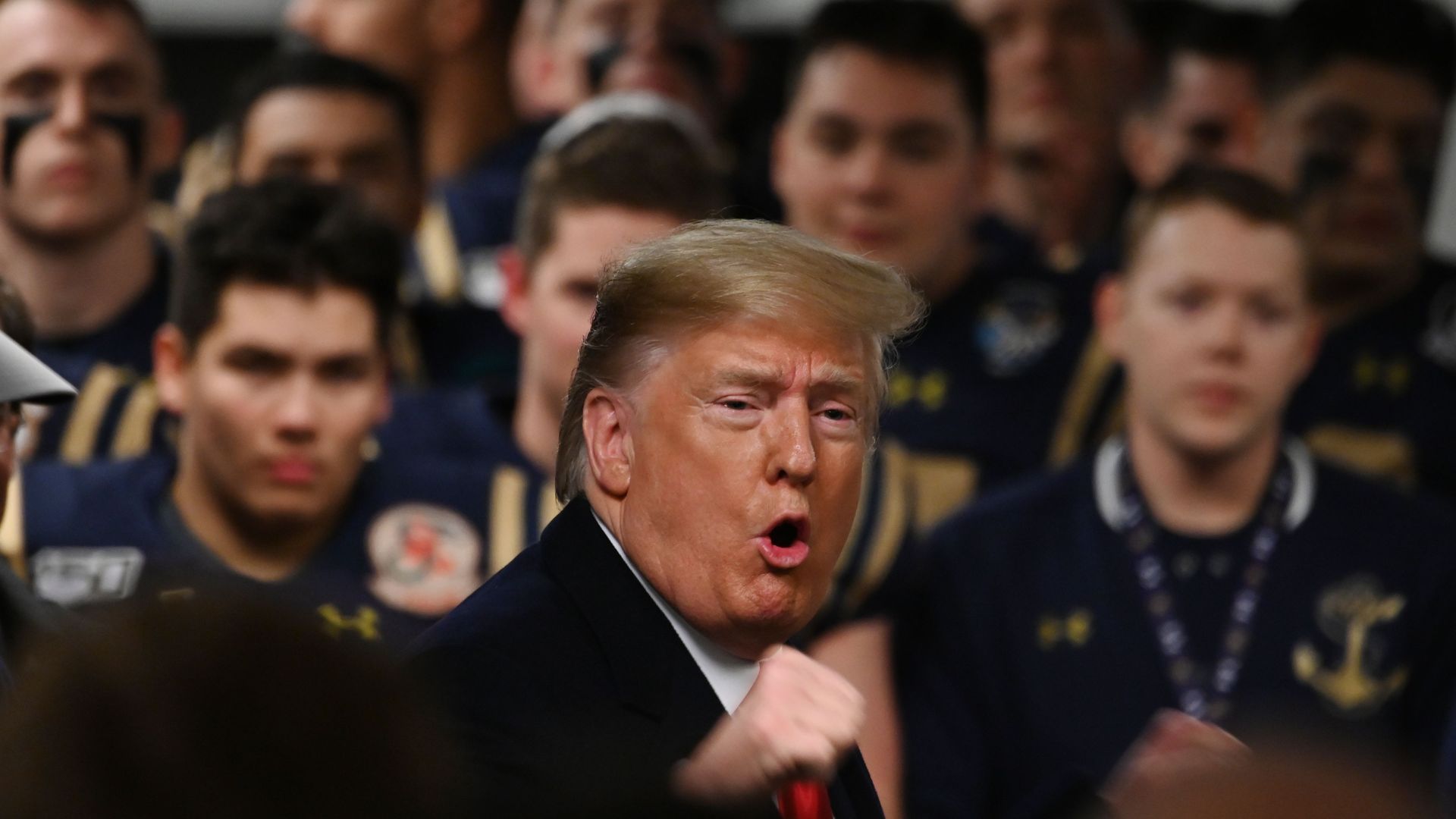  President Donald Trump speaks with Navy players in the locker room before the Army v. Navy American Football game in Philadelphia on December 14
