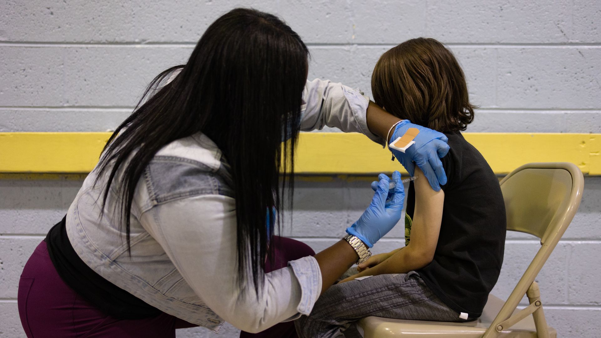 Picture of a health worker vaccinating a child