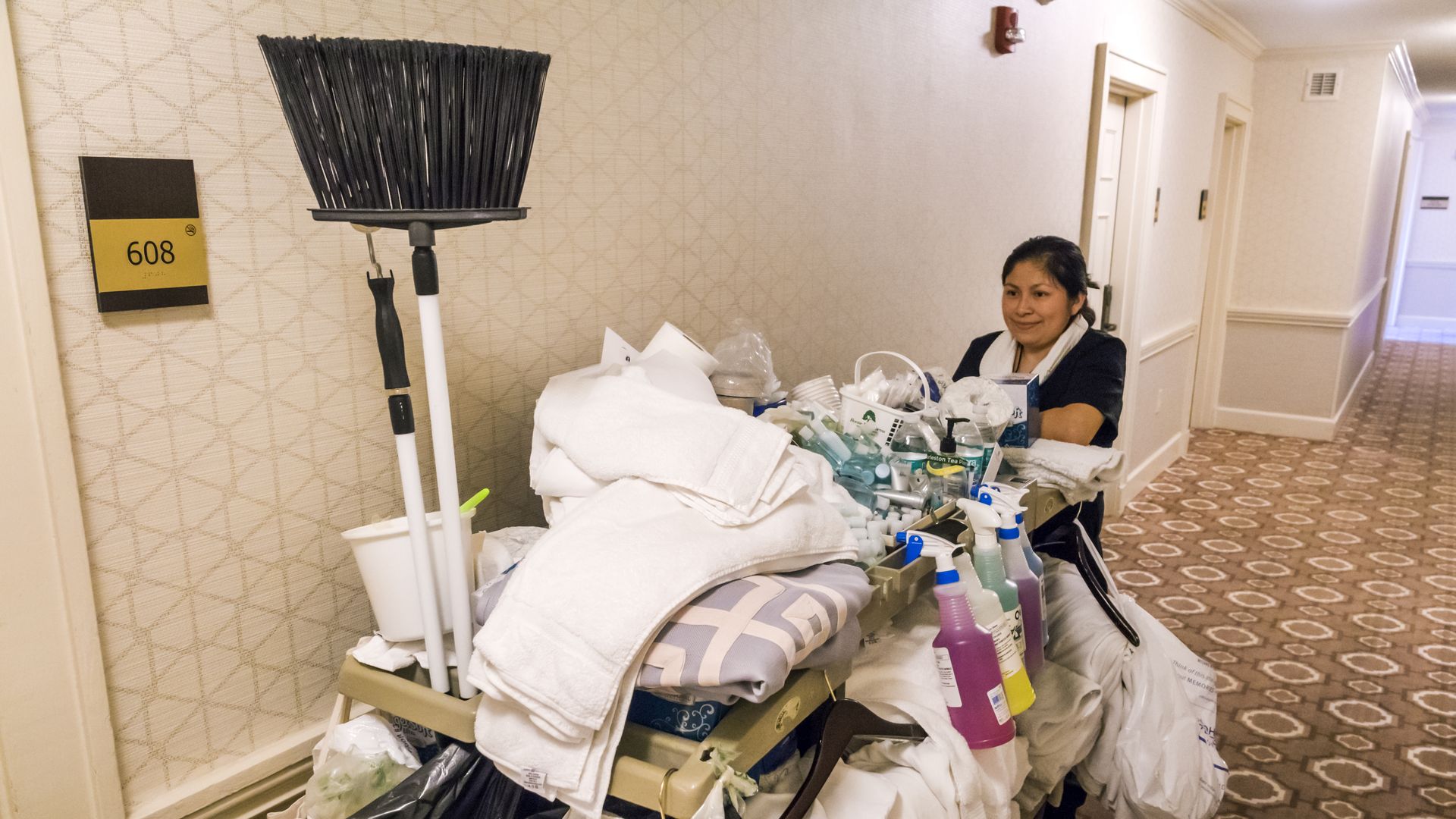 Image of a hotel housekeeper with cart