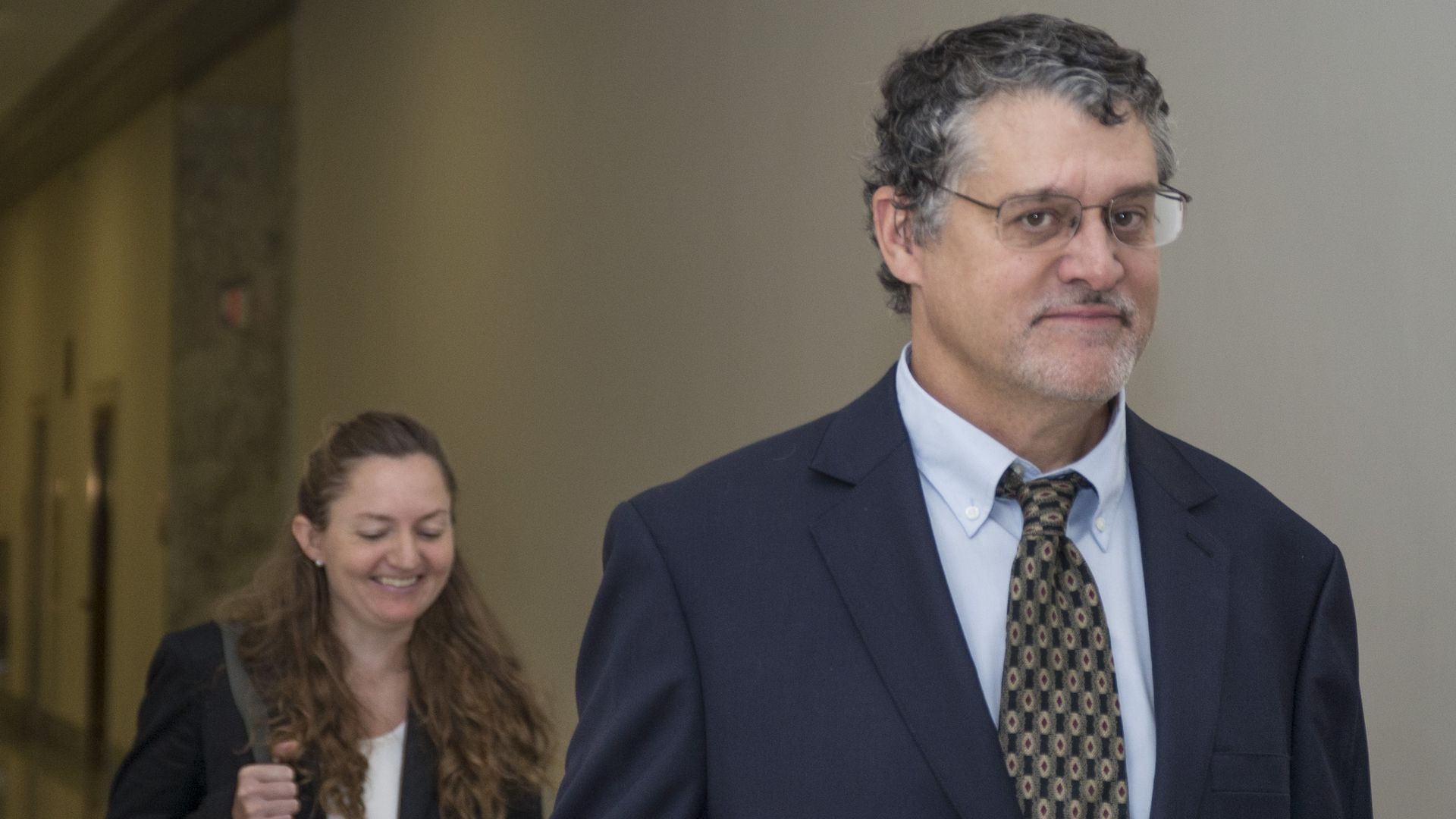 Glenn Simpson looks at the camera as he walks into a hearing. 