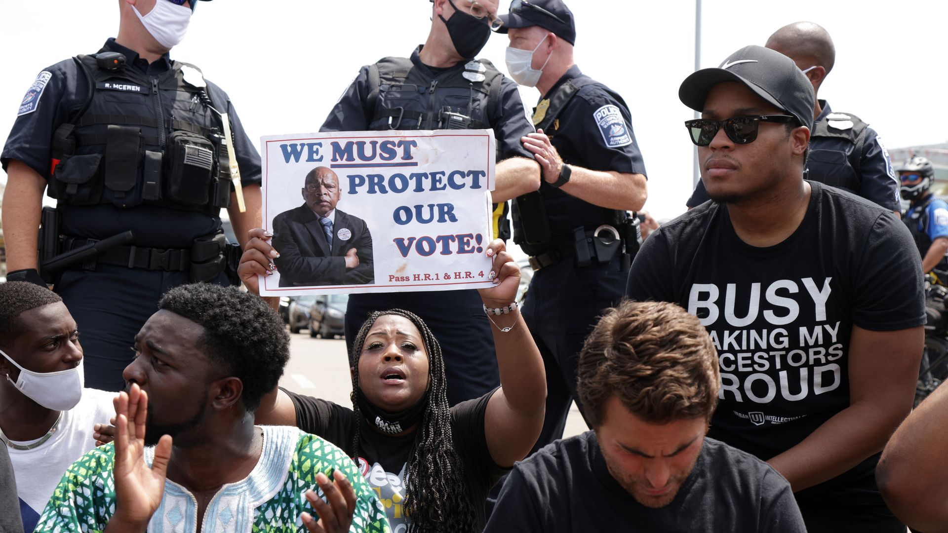 Shenita Binns of Atlanta, Georgia, holds up a sign that reads "We Must Protect Our Vote!" as she and other voting rights activists participate in a “Freedom Friday March” protest.
