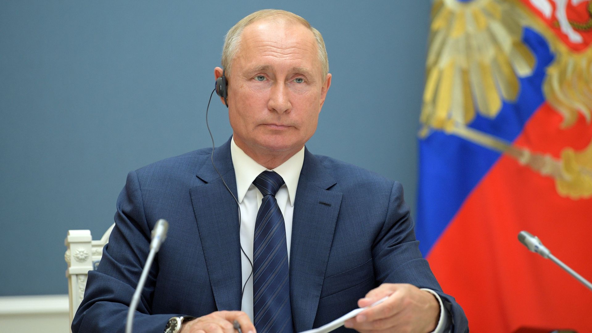 Russian President Vladimir Putin attends by a video conference 