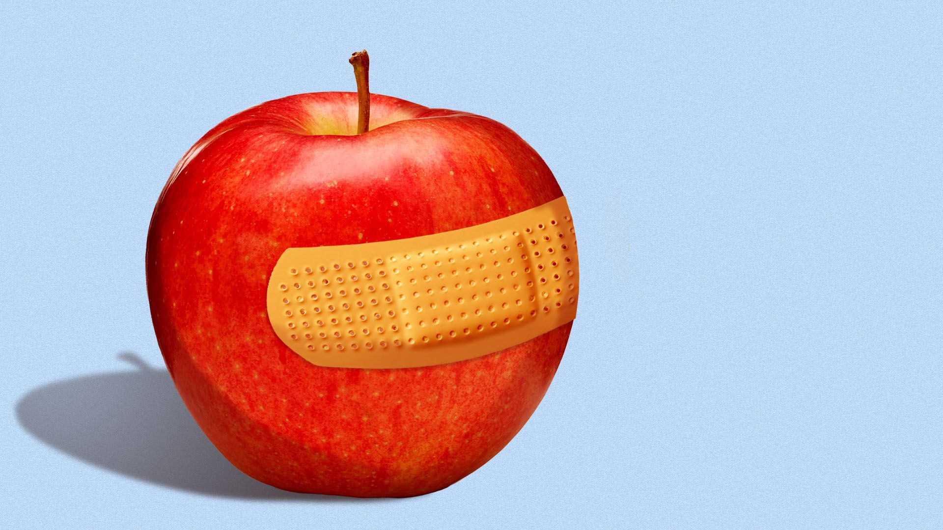 Apple with a bandaid on it