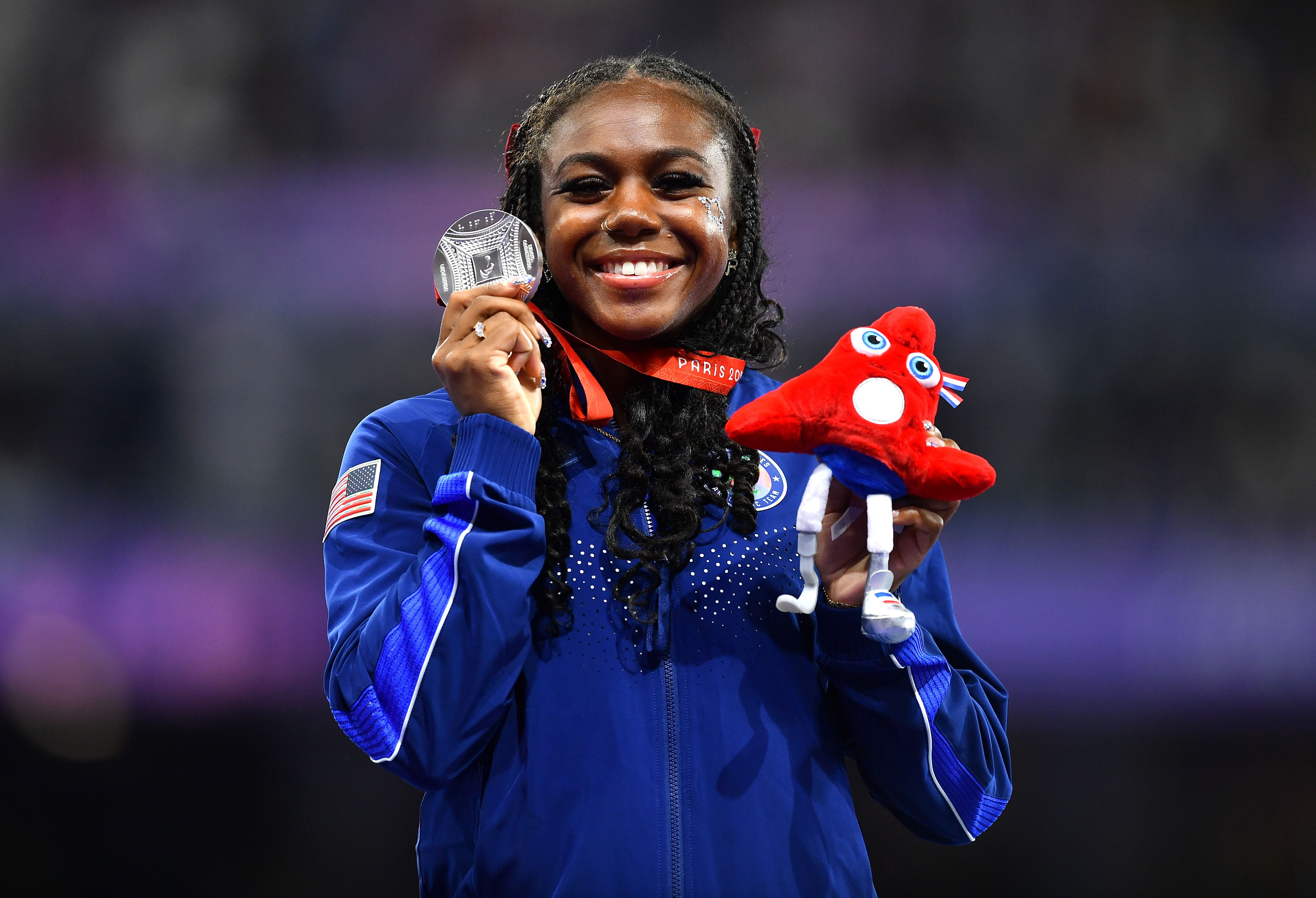 Brittni Mason poses for a photo with her silver medal