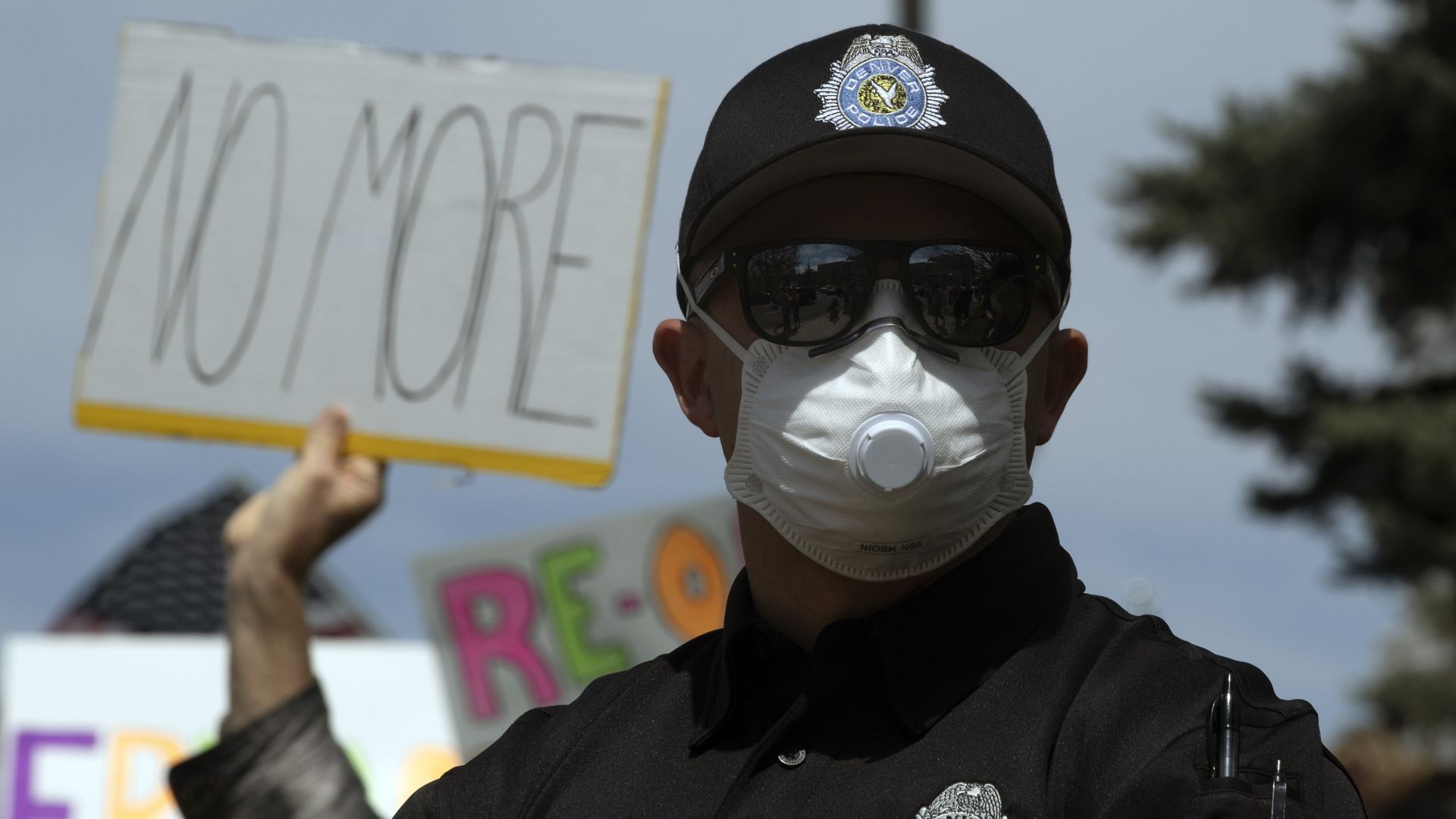 A photo of a Denver police officer wearing a face mask and sunglasses