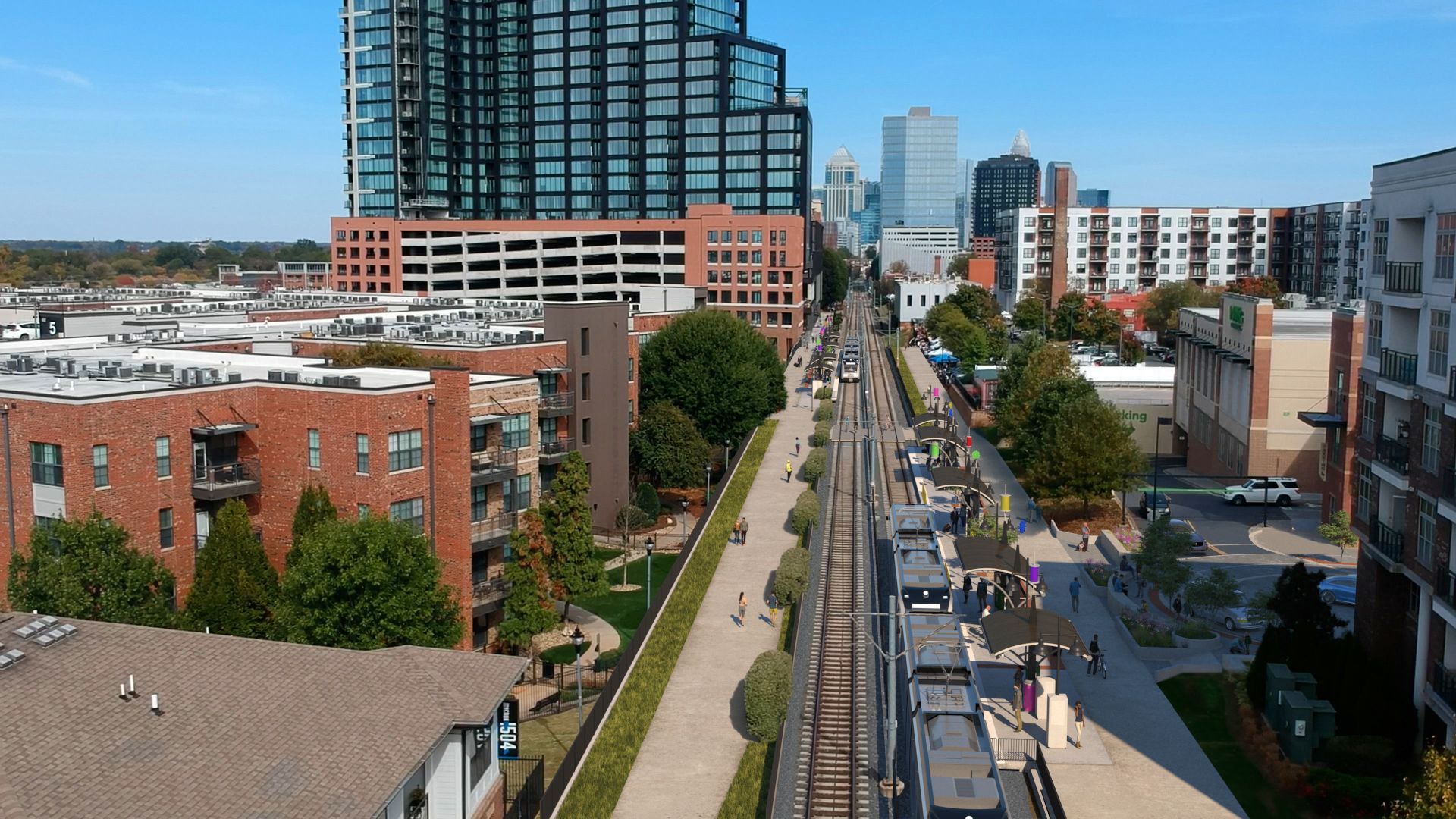 Rendering of train tracks, a stop and buildings on either side from an aerial view