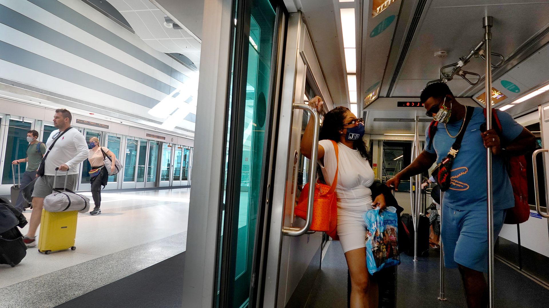 People wearing masks aboard a tram in the Miami International Airport in Florida on Sept. 3.