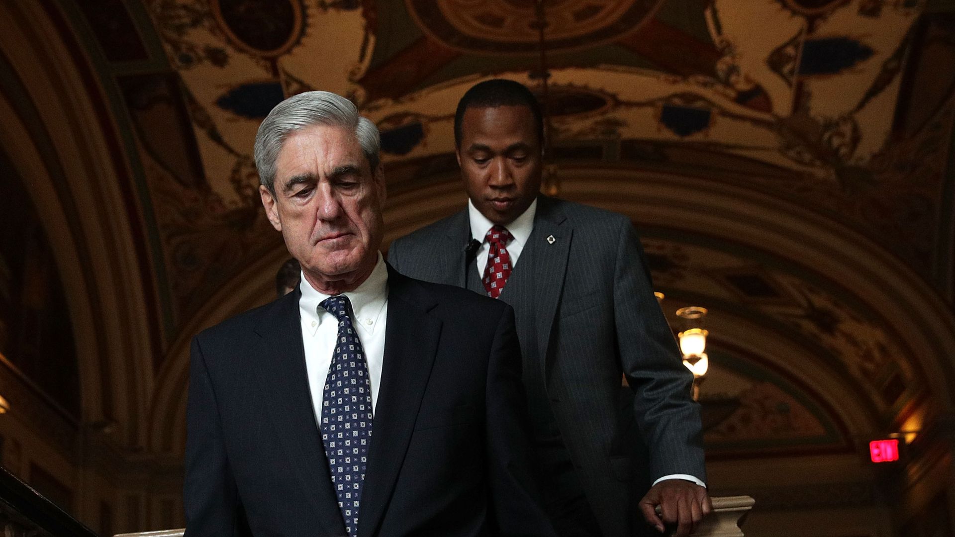 Robert Mueller walks down a flight of stairs in the Capitol