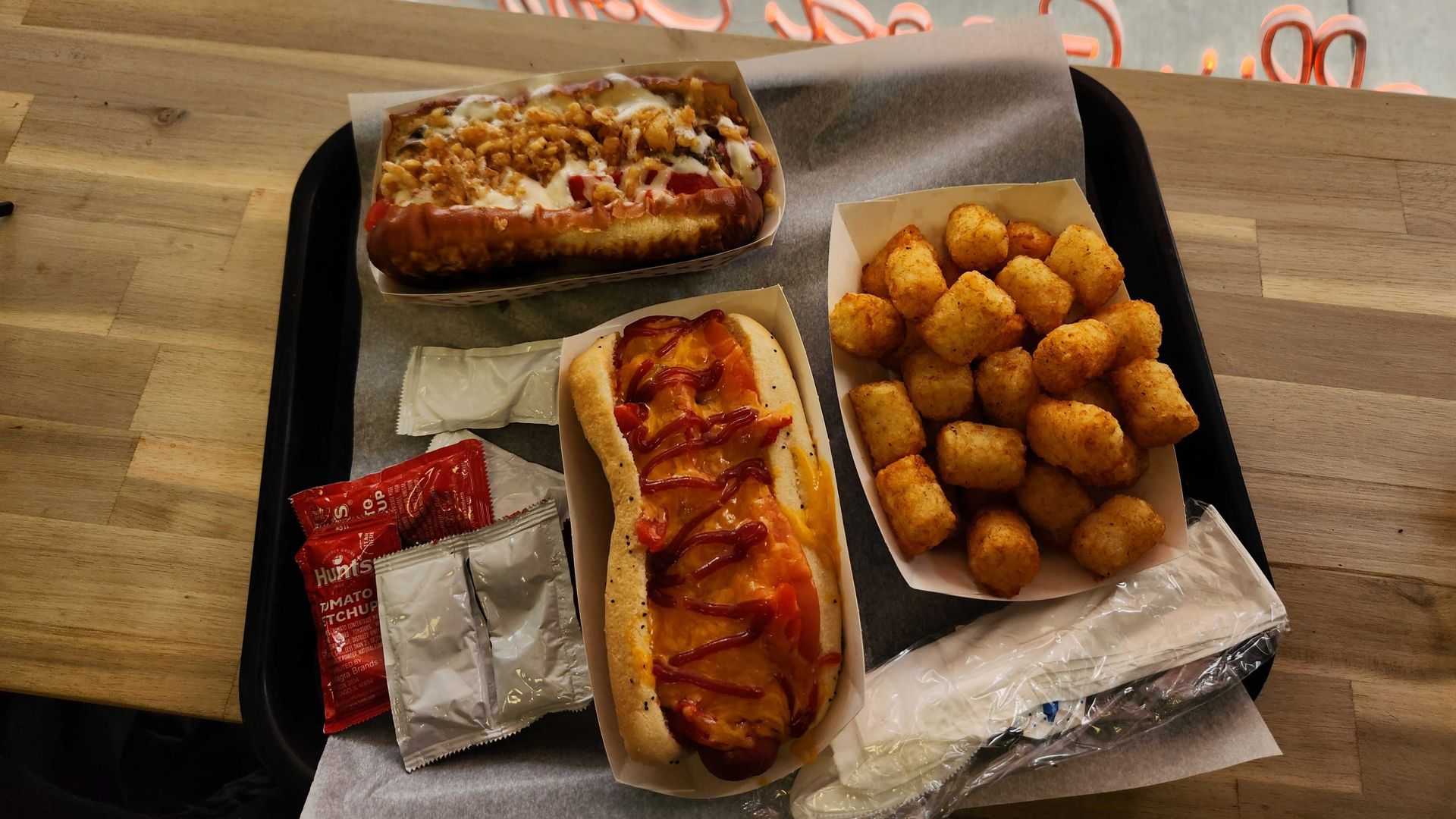 A lunch platter of hot dogs and tater tots.