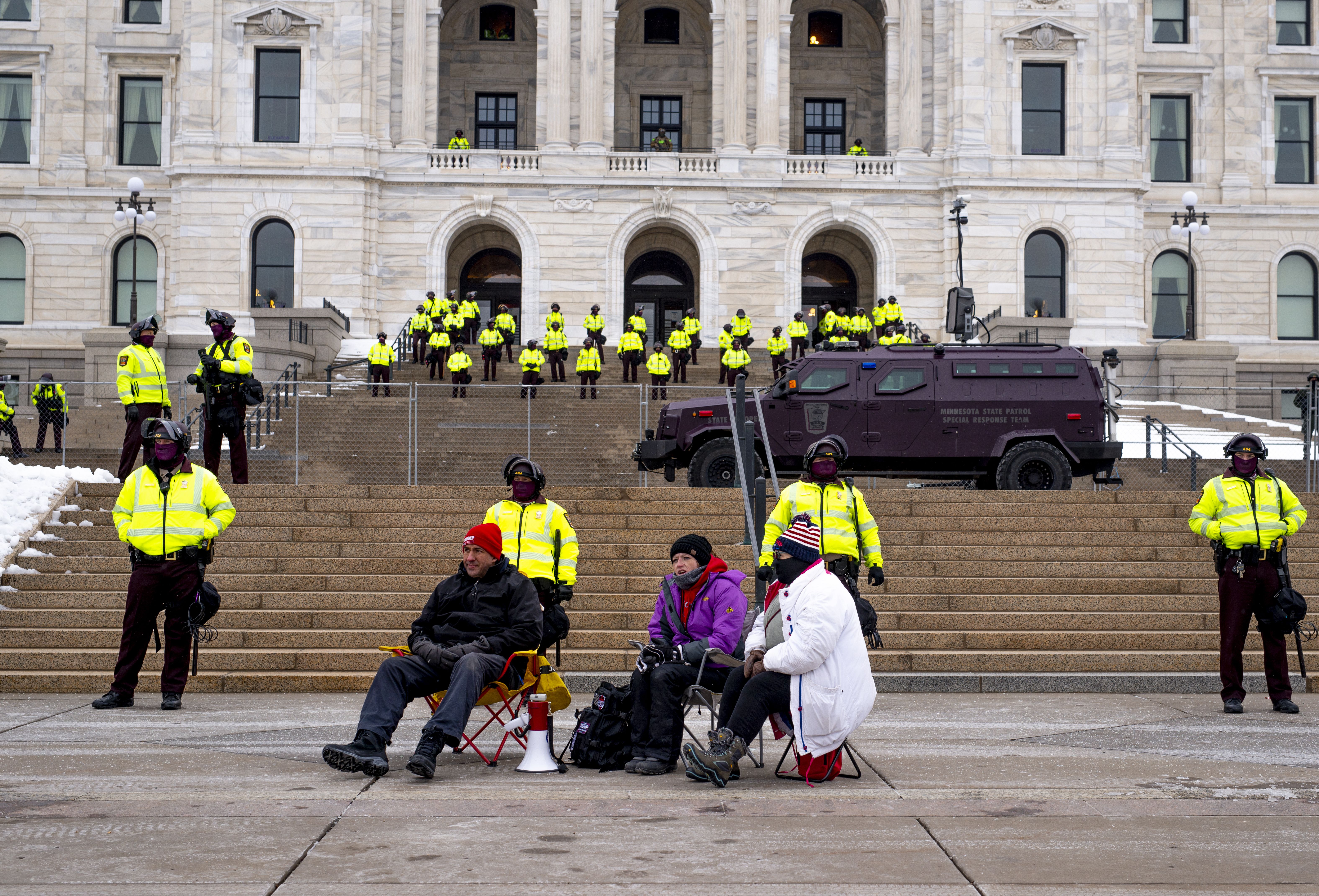 Minnesota State Patrol stand guard as a small group of people who support President Donald Trump sit outside the Minnesota Capitol building on January 17, 2021 in St Paul