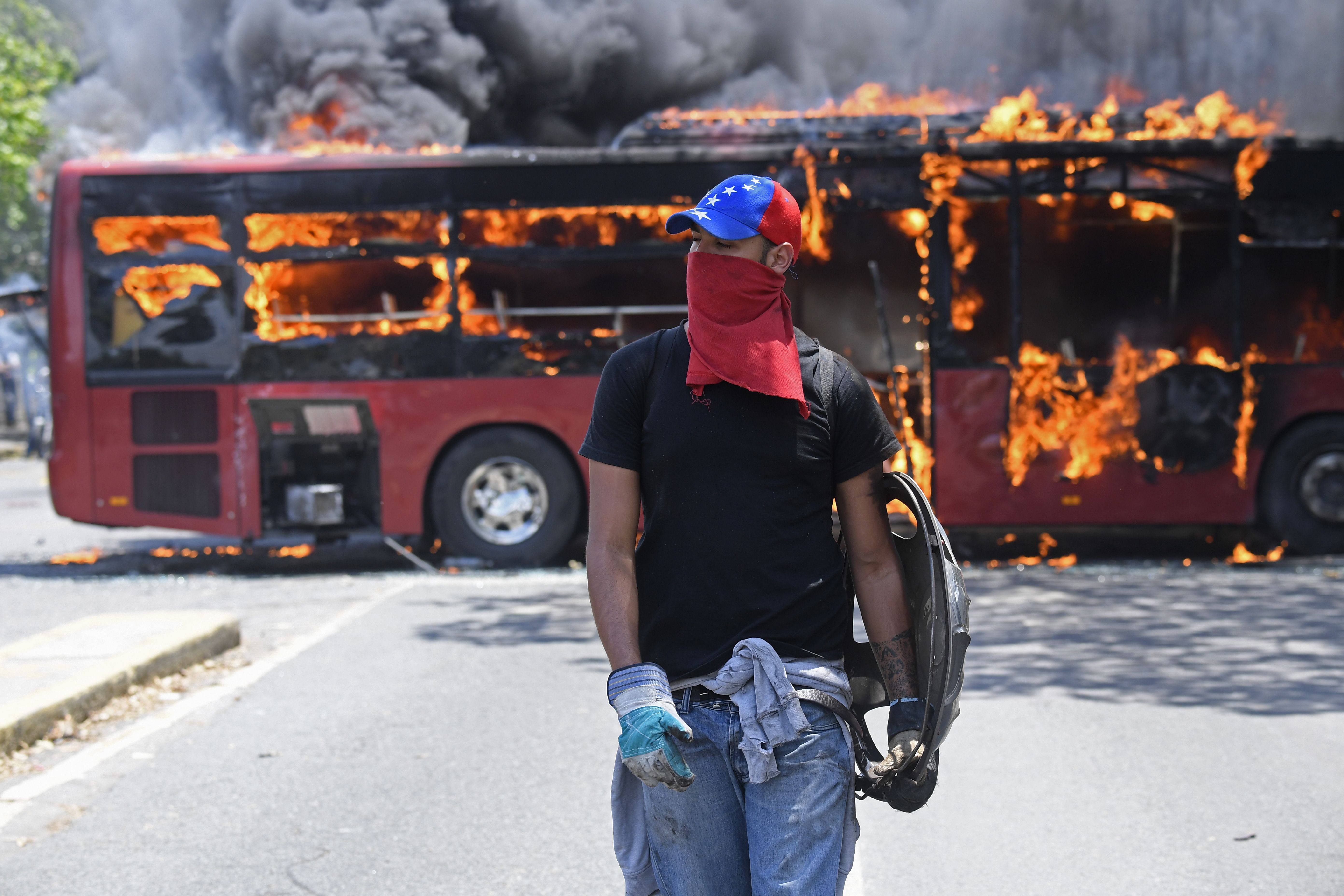 A government bus set on fire during clashes. 