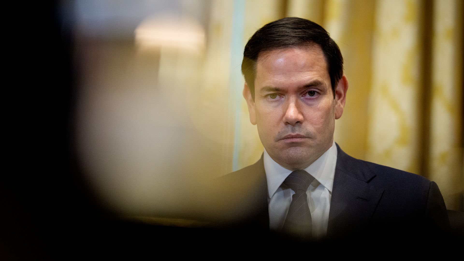 Marco Rubio looks on during a Cabinet meeting.