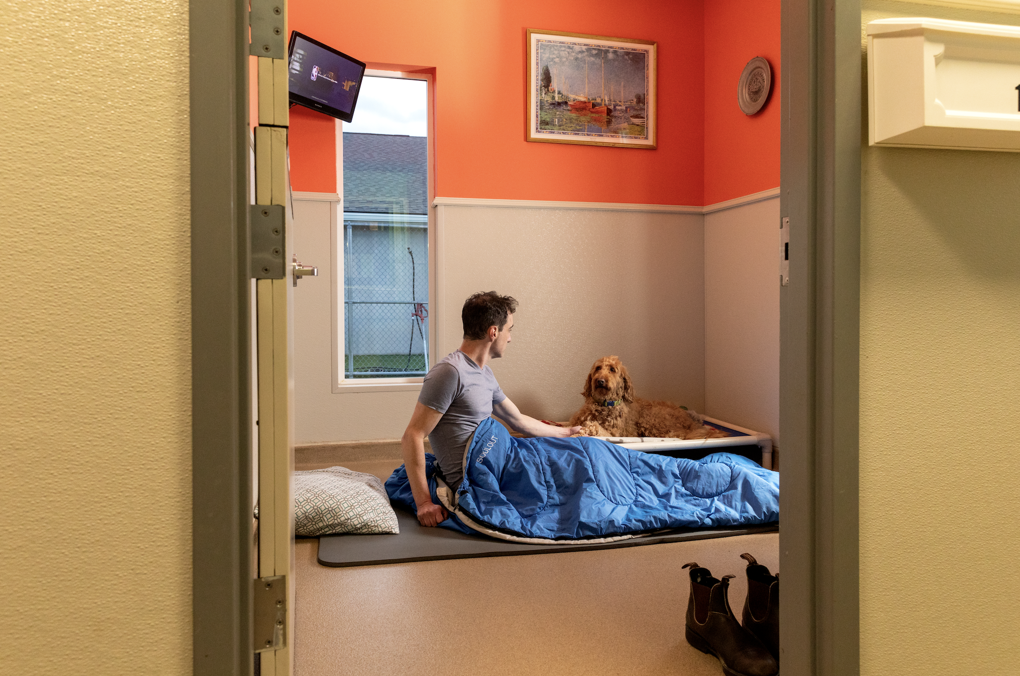 A man and a goldendoodle