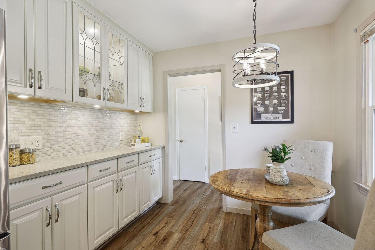 glass-front cabinets and eating nook in kitchen