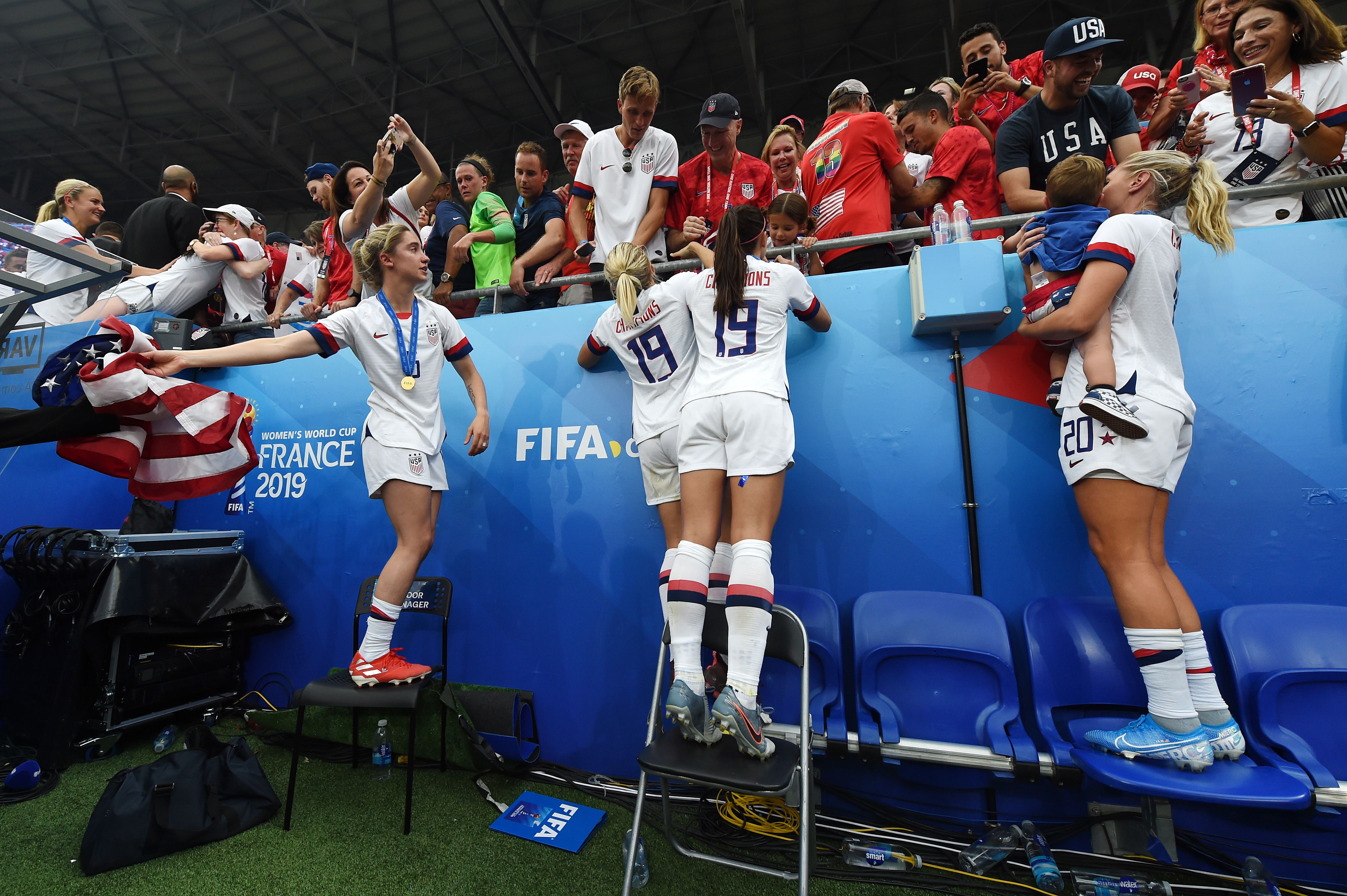 USA players celebrate victory with family and friends in the crowd after the 2019 FIFA Women's World Cup France Final match between The United States of America and The Netherlands at Stade de Lyon.