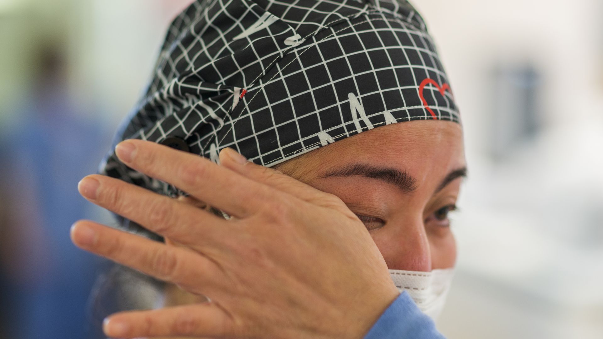 A nurse wipes away tears inside the Covid-19 unit of Salinas Valley Memorial Hospital in California. Photo: Nic Coury/Bloomberg via Getty Images
