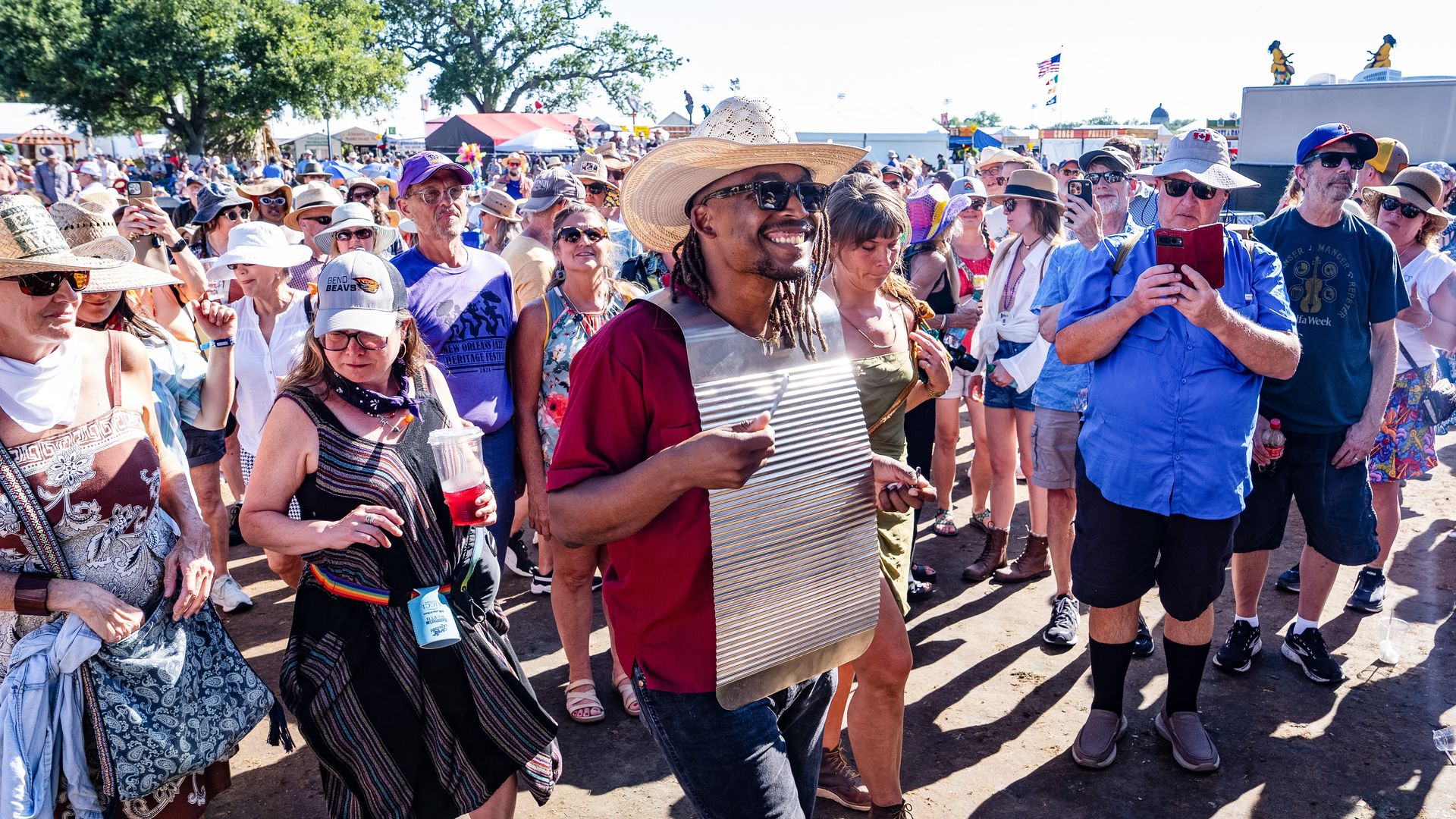 A washboard player with Jourdan Thibodeaux & Les Rôdailleurs performs in the crowd during 2025 New Orleans Jazz & Heritage Festival.
