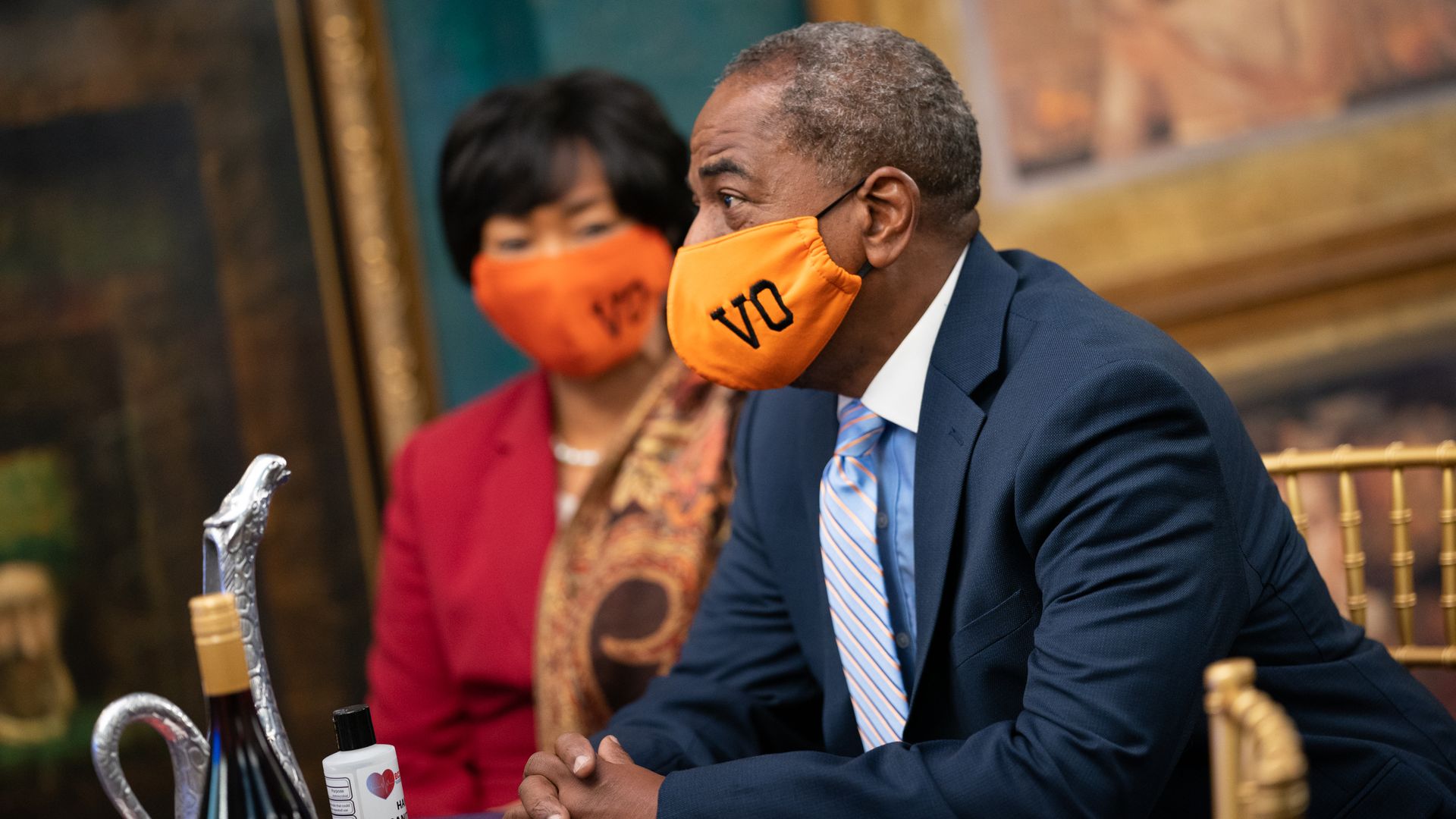 Vincent Orange shown wearing an orange mask bearing his initials "VO."