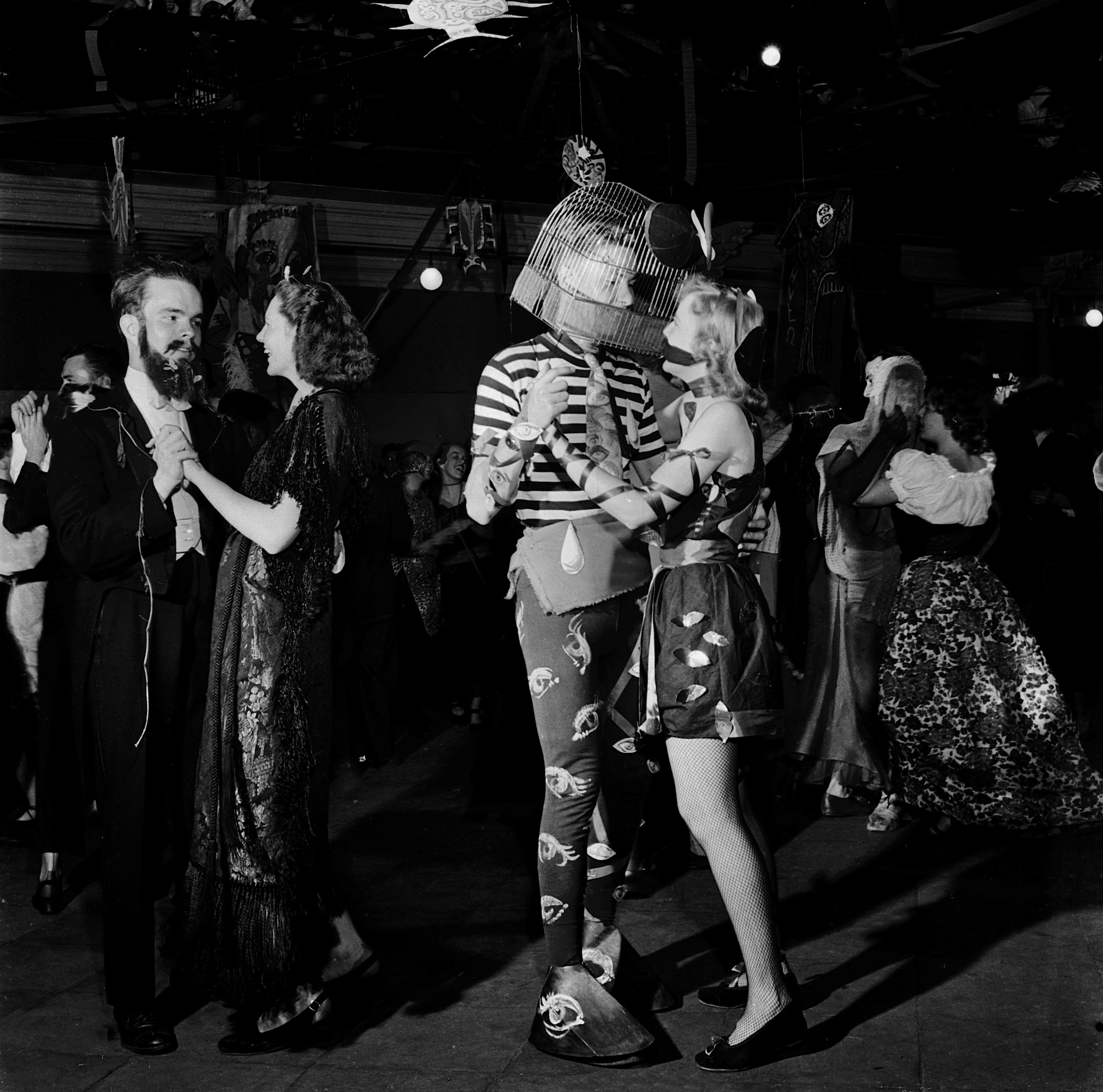 Photo of people dancing in Halloween costumes. 
