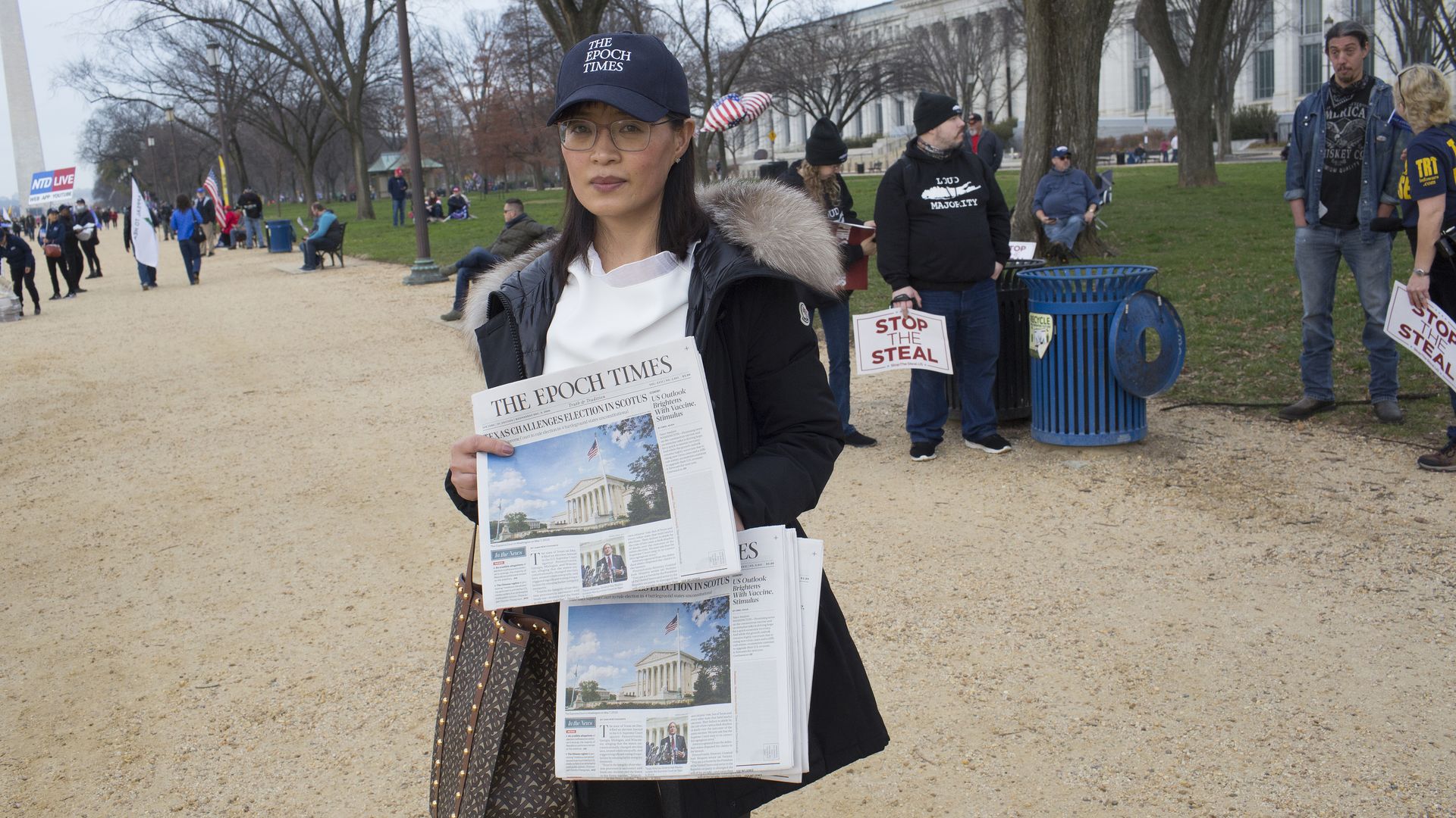 A vendor is seen distributing copies of the Epoch Times newspaper on the National Mall in Washington, D.C.