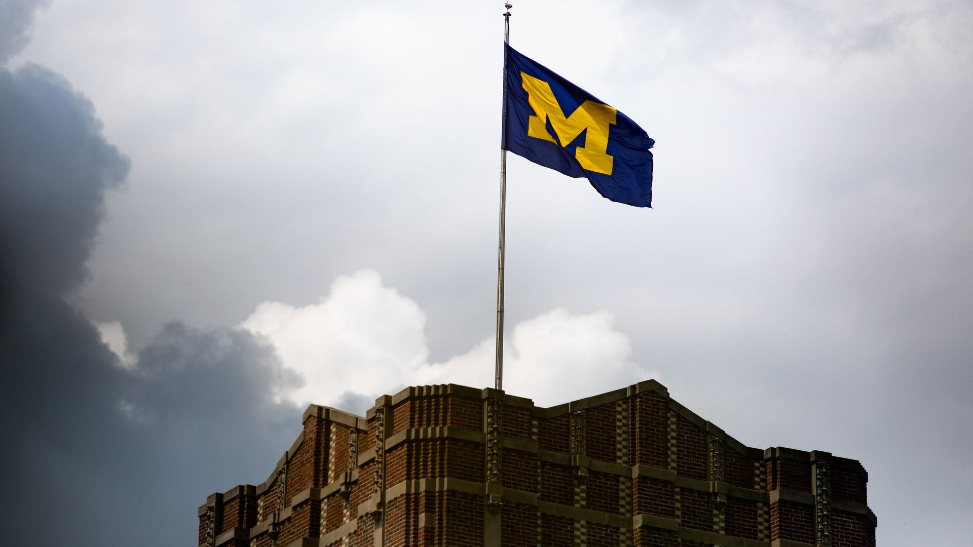A U-M flag on the Michigan Union in Ann Arbor.
