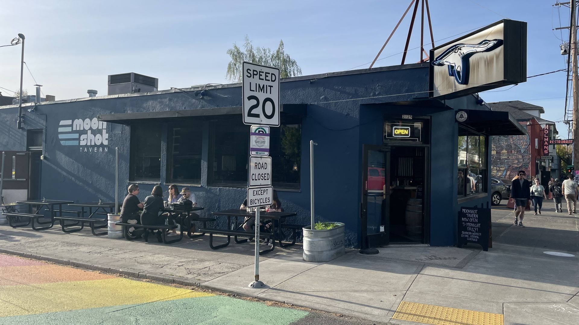 A photo of the exterior of a building with a goose sign.