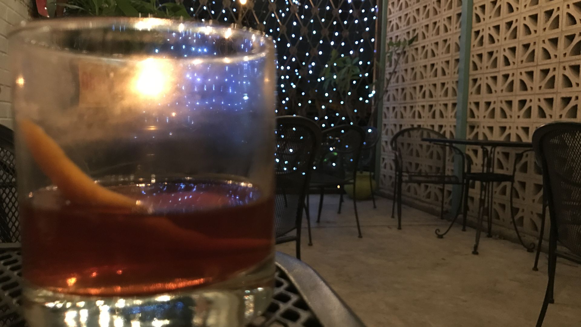 An old fashioned in front of Christmas lights
