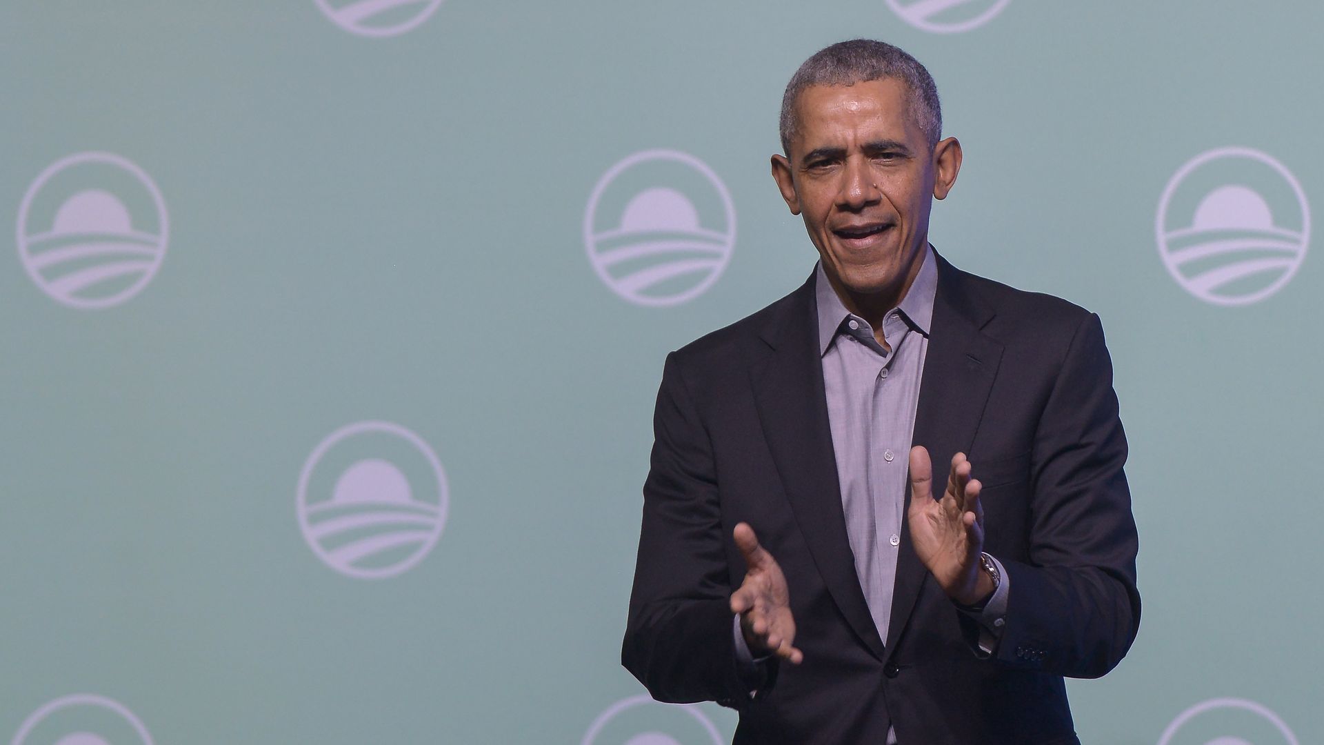 President Barack Obama gesture on the stage as he attends an Obama Foundation event in Kuala Lumpur, Malaysia, 13 December 2019.