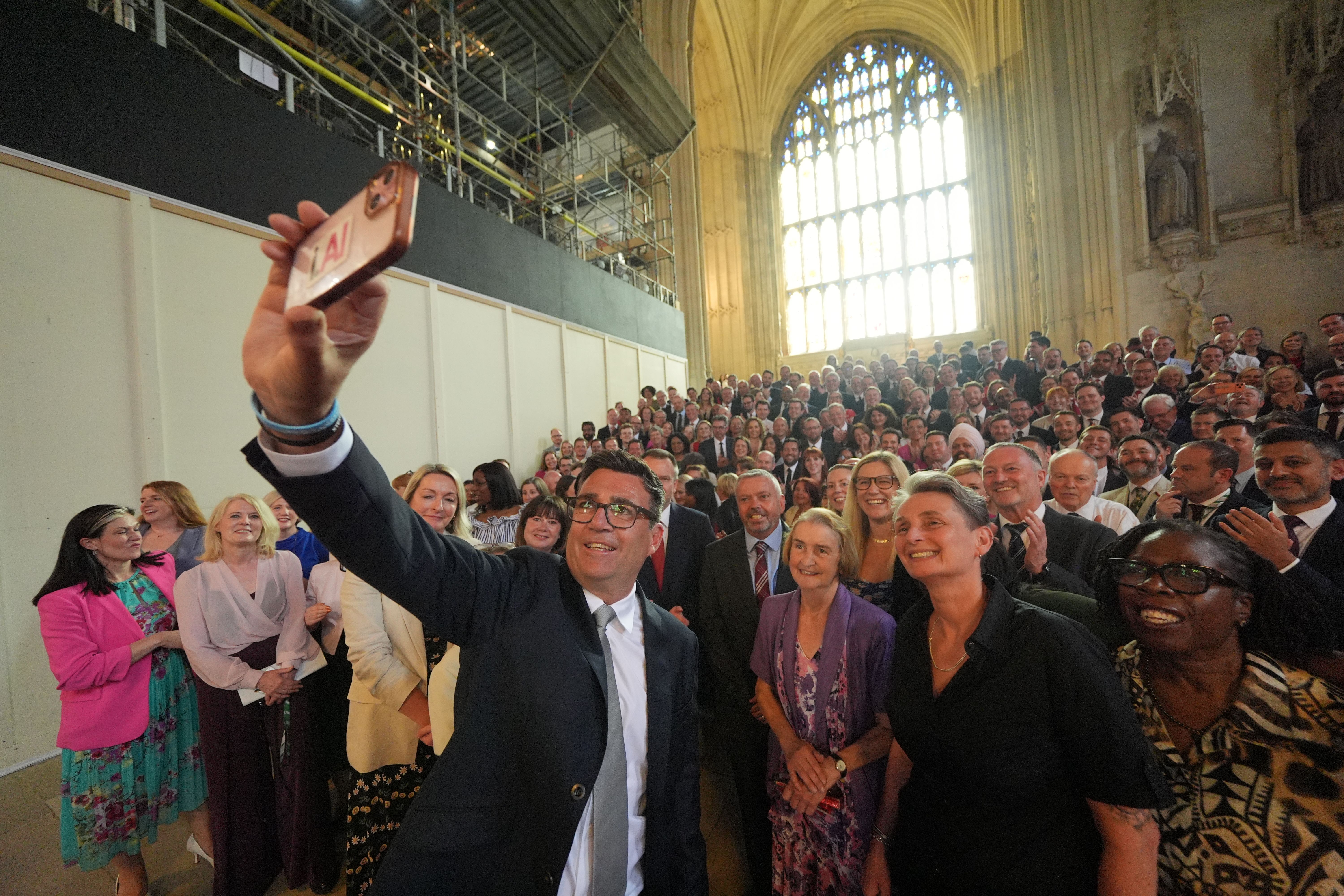 British lawmaker Andy Burnham takes a selfie with Labour Party colleagues at the Houses of Parliament today. Photo: Yui Mok/PA Images via Getty Images